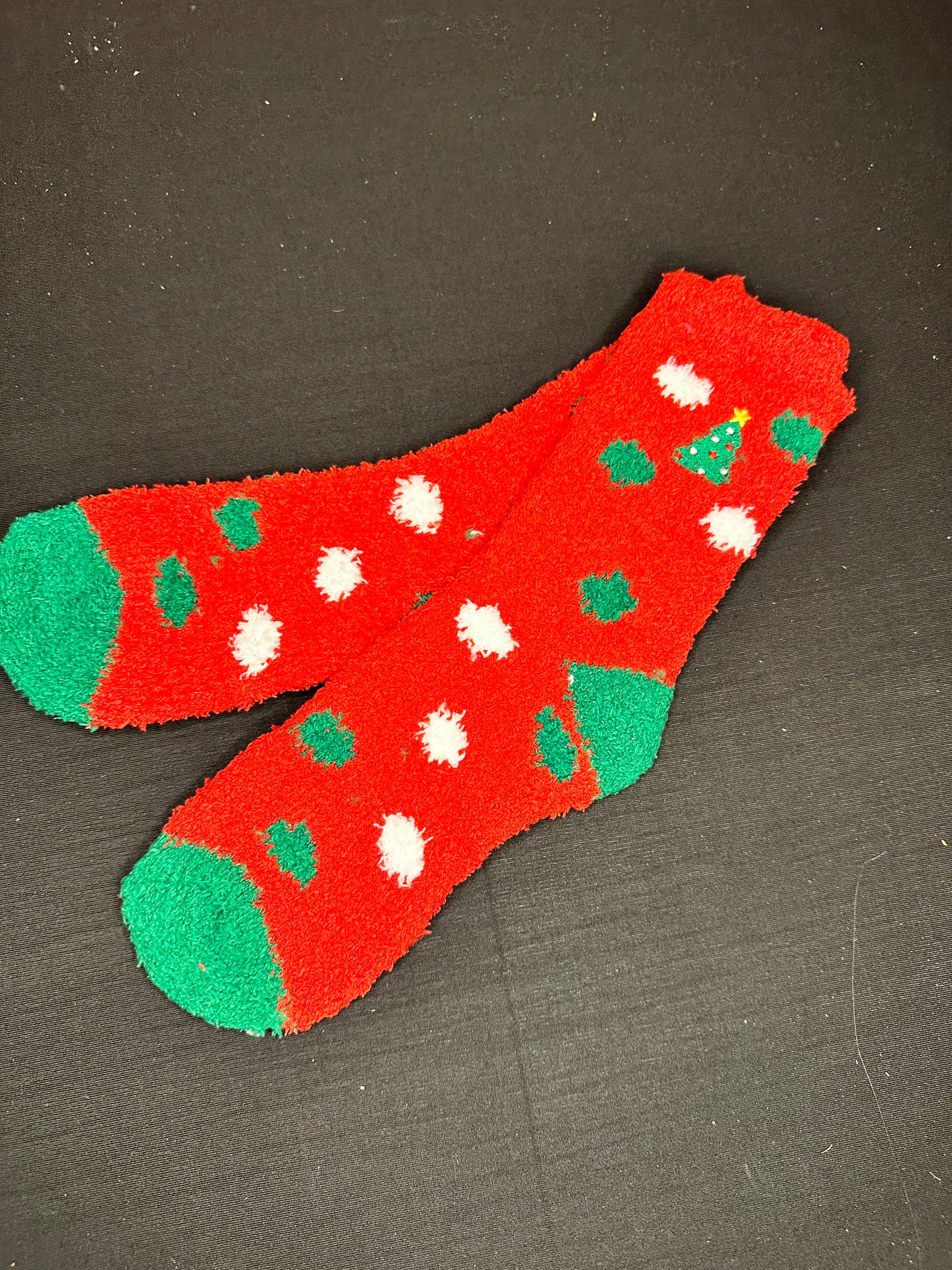 Red fuzzy socks with green and white polka dots and embroidered Christmas tree