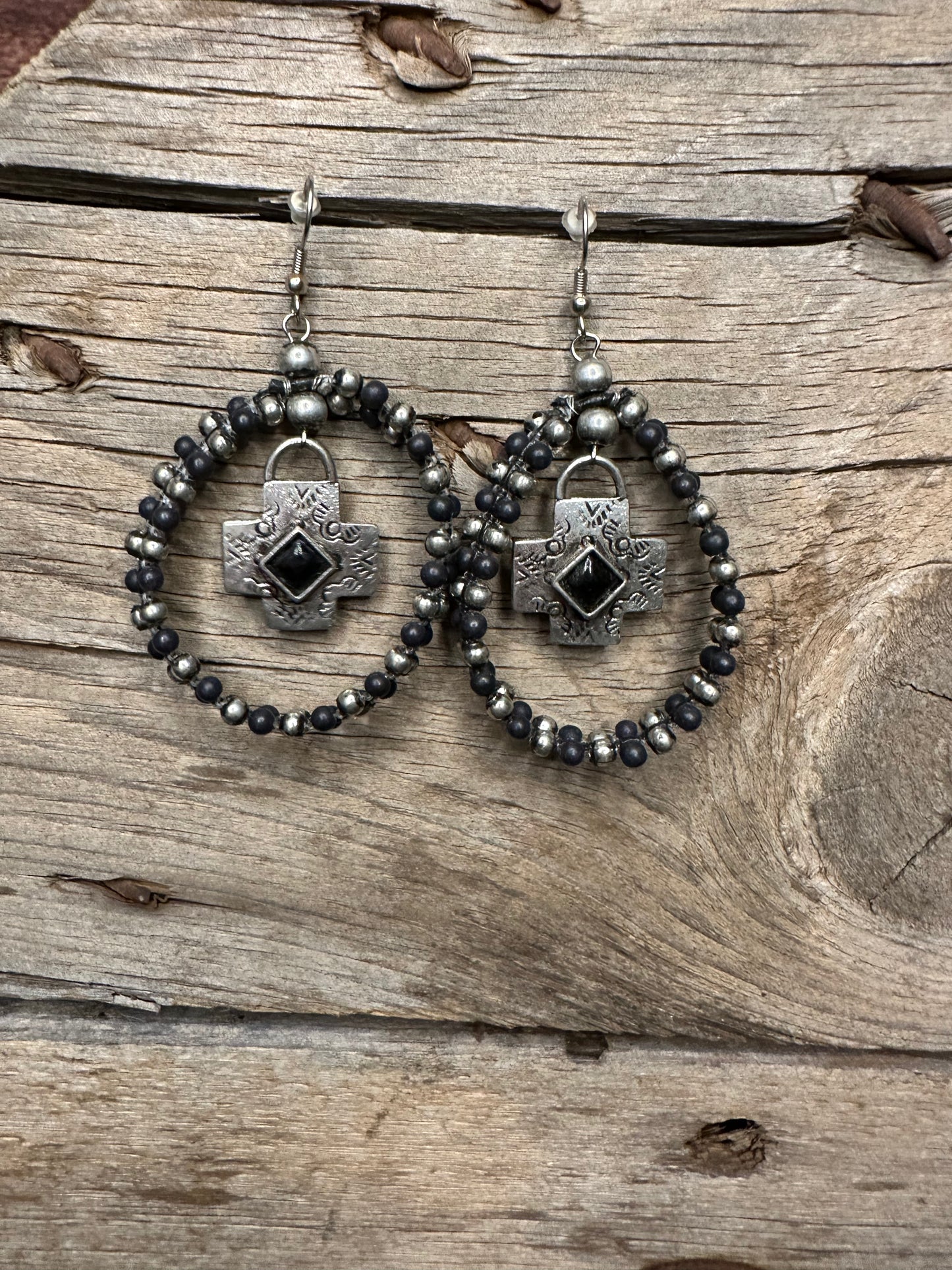 Black and Navajo pearl beaded hoop dangle earrings with silver cross in the center