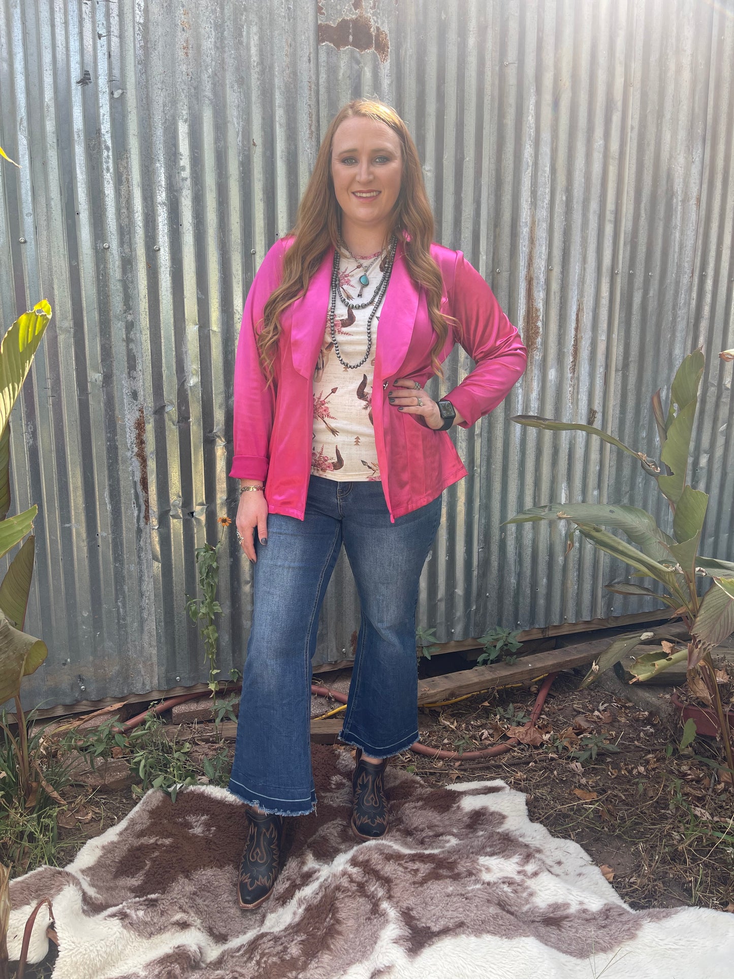 Woman wearing hot pink silky blazer in size large