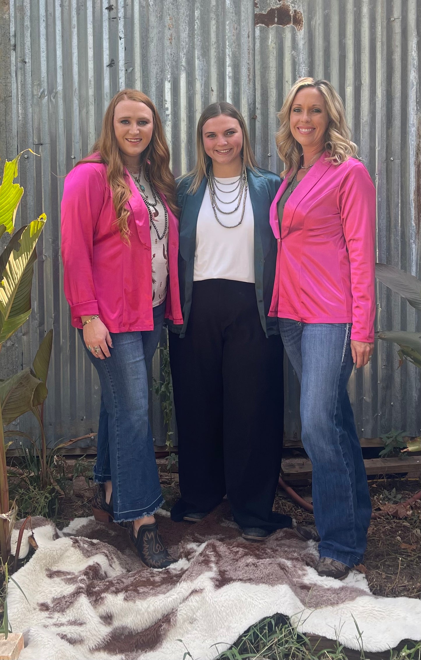 three women wearing silky blazers in different sizes