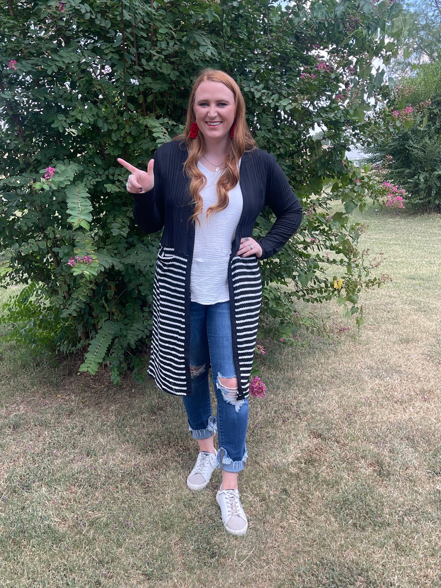 Woman wearing long black and white striped duster in size medium
