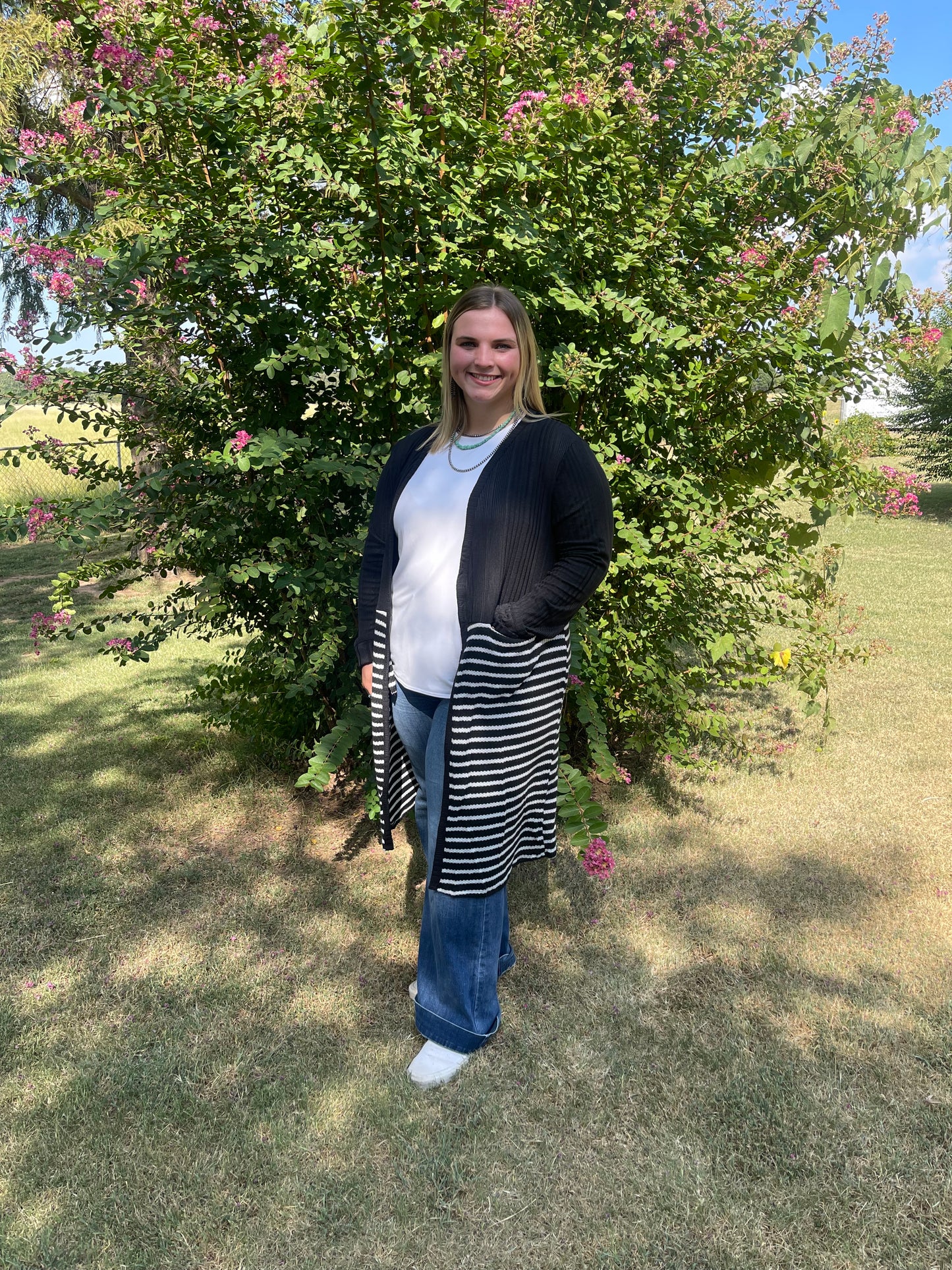 Woman wearing long black and white striped duster with pockets in X-large