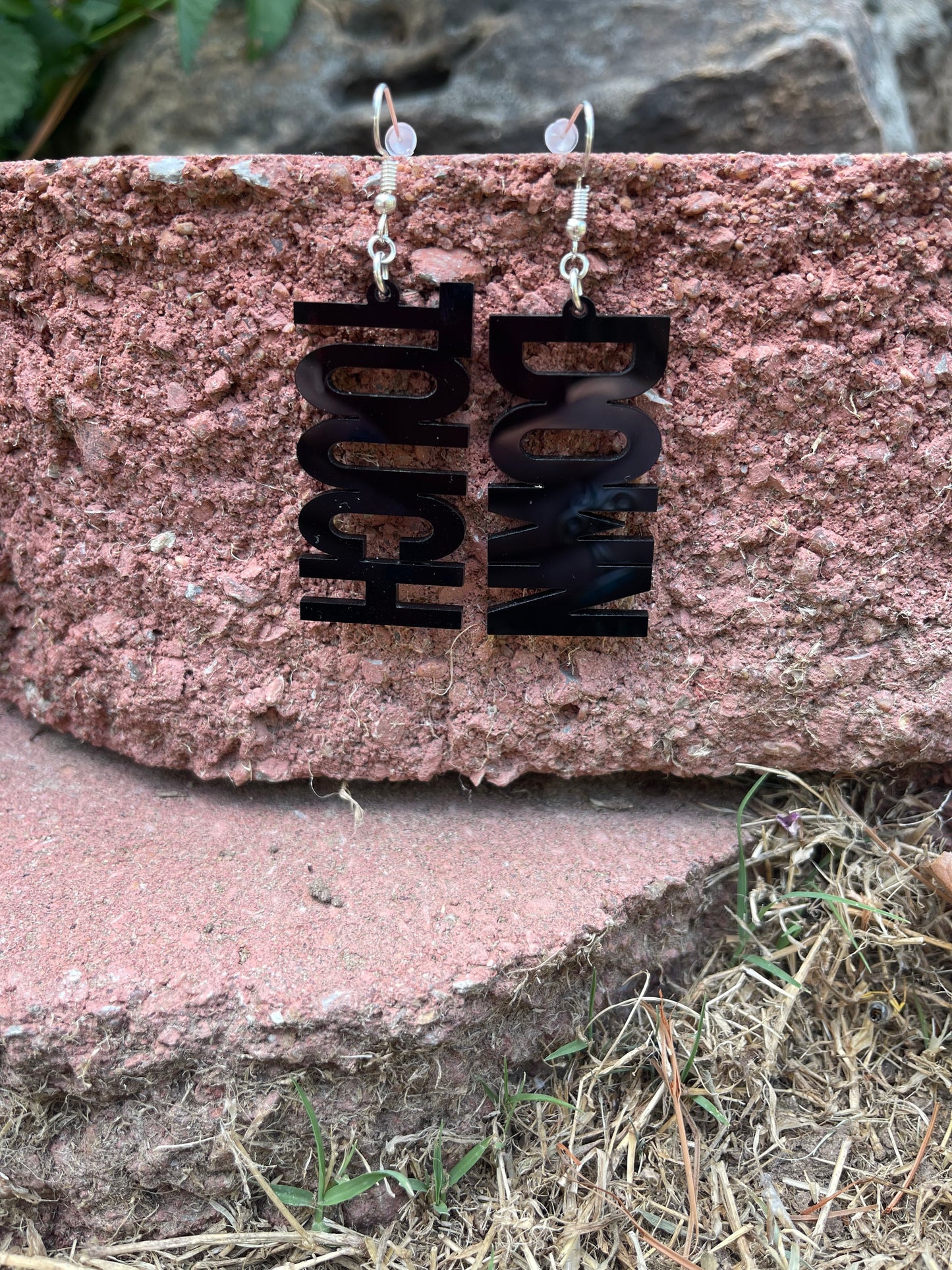 Black earrings that say TOUCH and DOWN