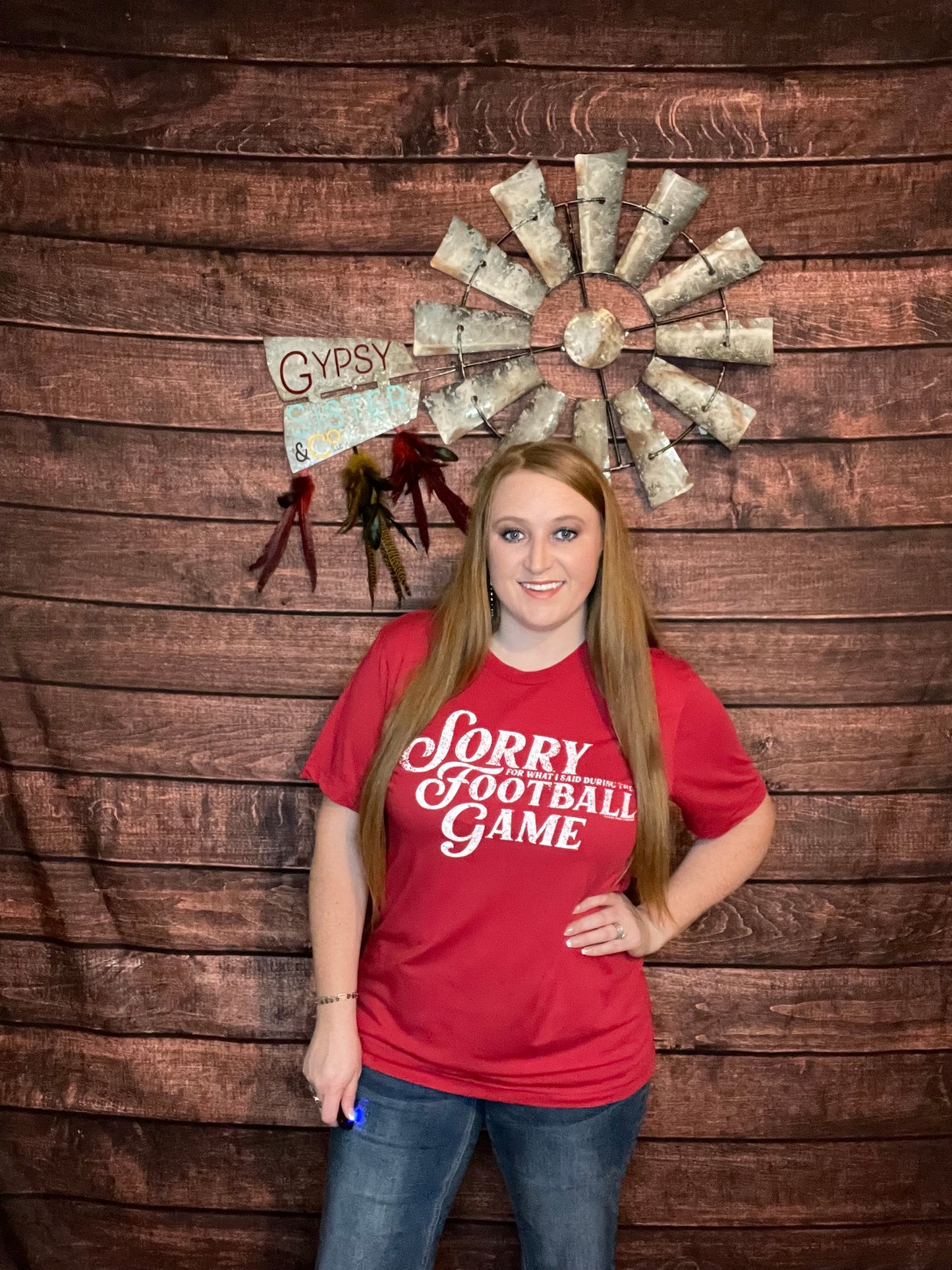 Model wearing Red "sorry for what I said during the football game" tee