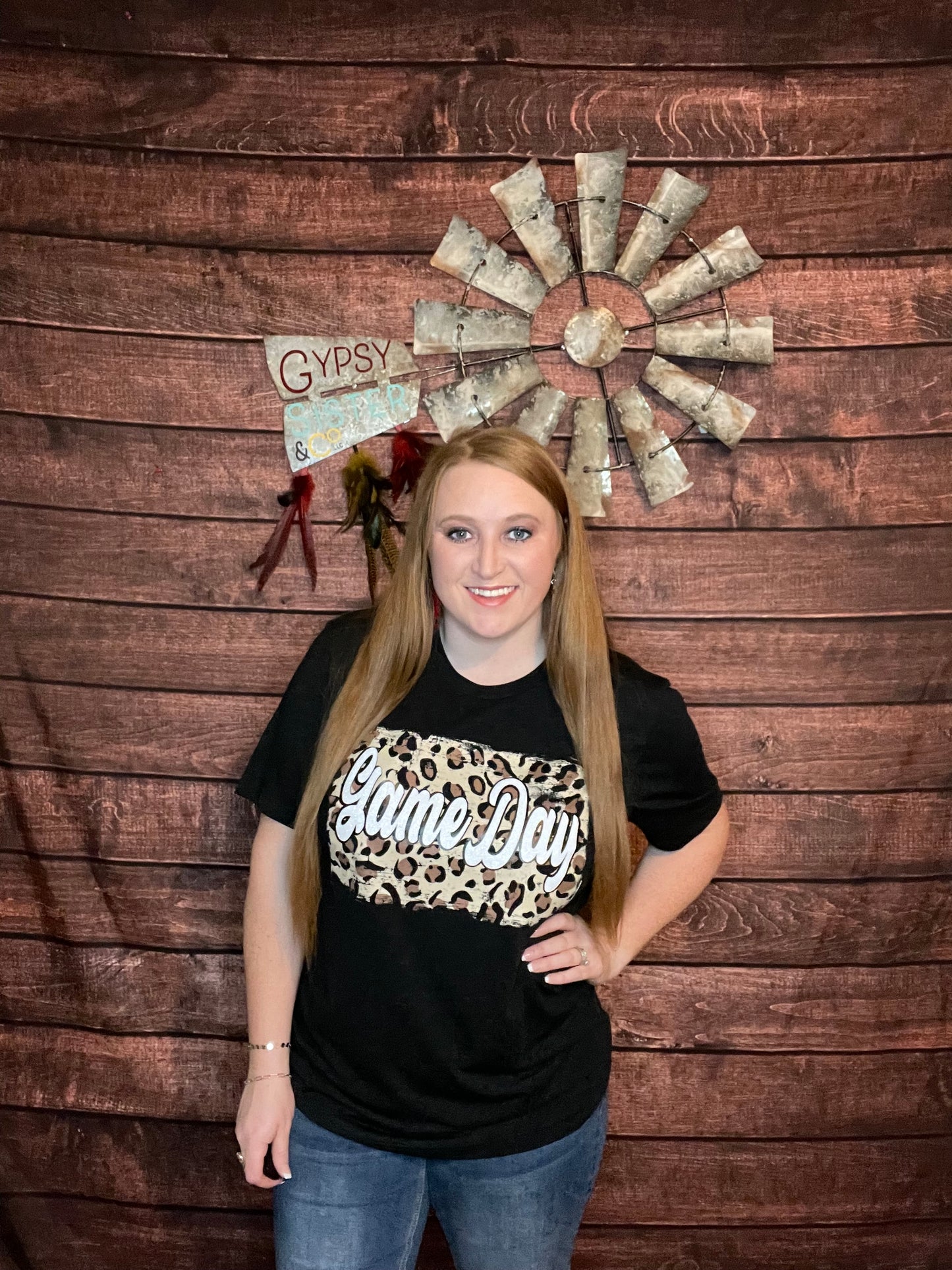 Model wearing black t-shirt with Cheetah back ground and white glitter letters that spell out Game Day