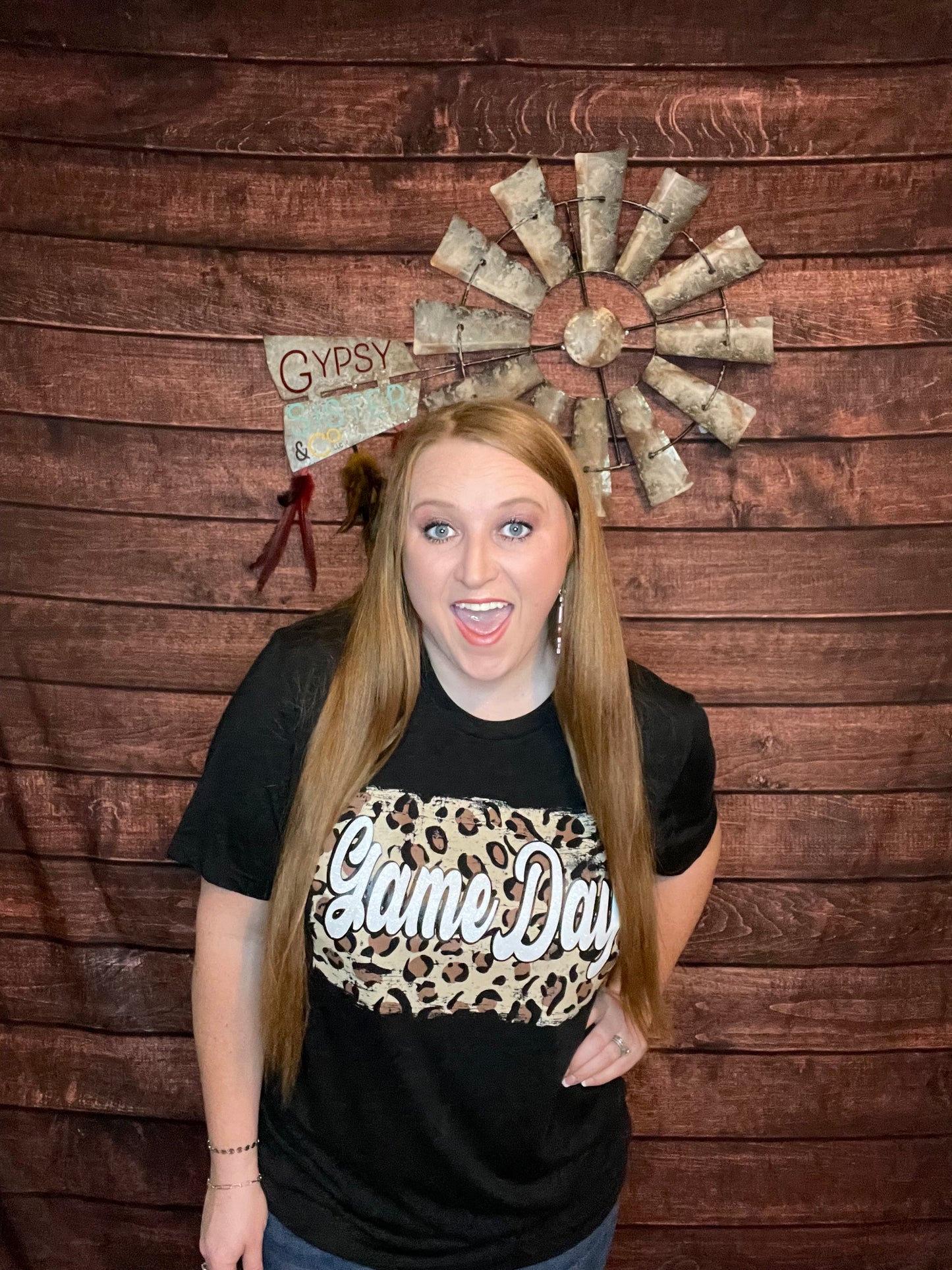 Model wearing black t-shirt with Cheetah back ground and white glitter letters that spell out Game Day