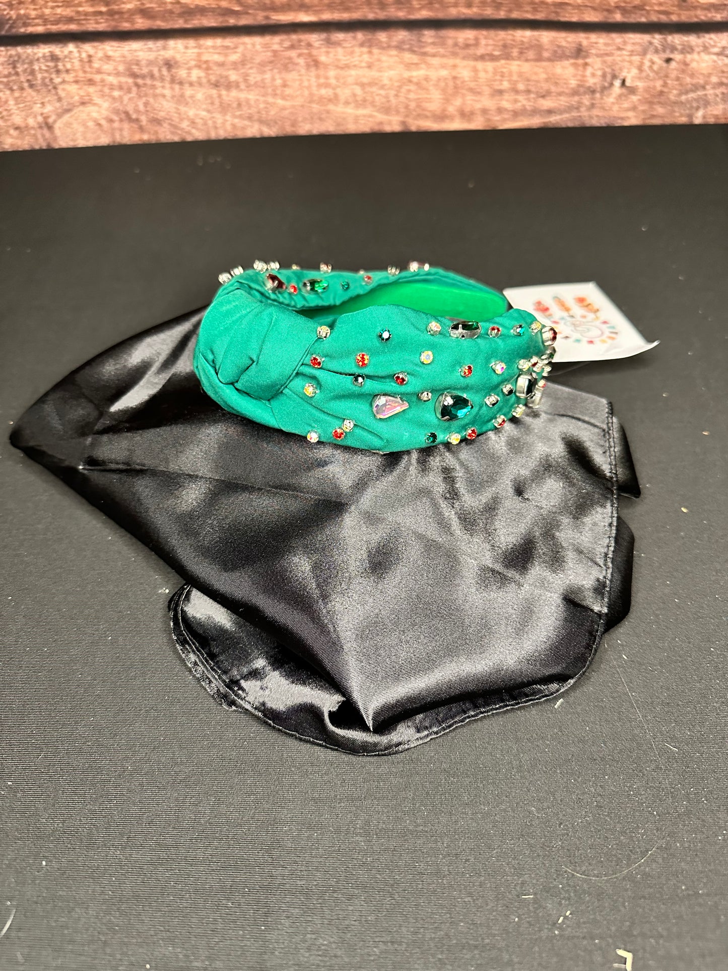 Green knotted headband with colorful jewels