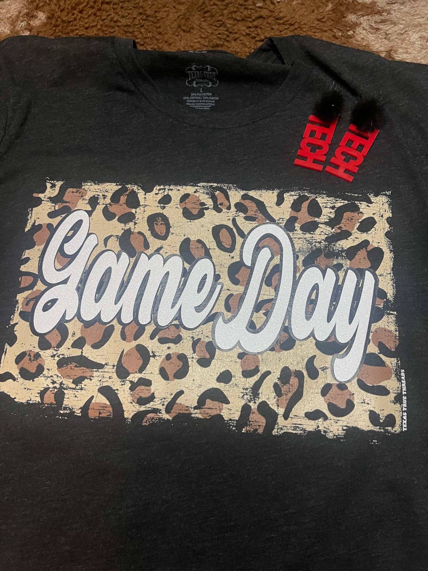Black t-shirt with Cheetah back ground and white glitter letters that spell out Game Day