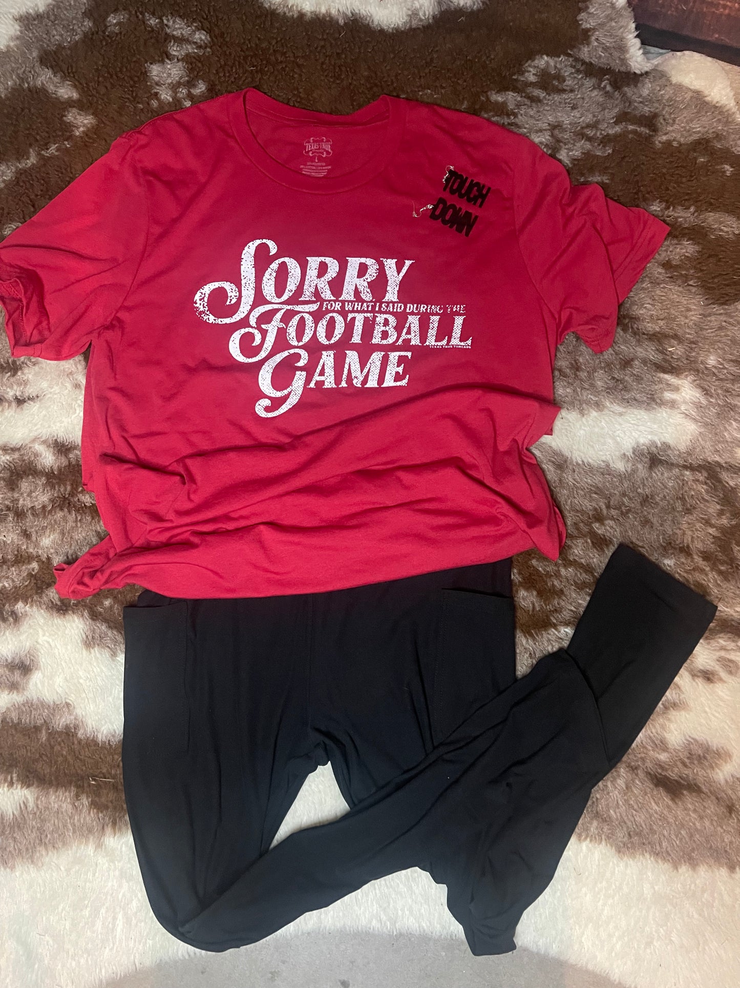 Red "sorry for what I said during the football game" tee with black leggings