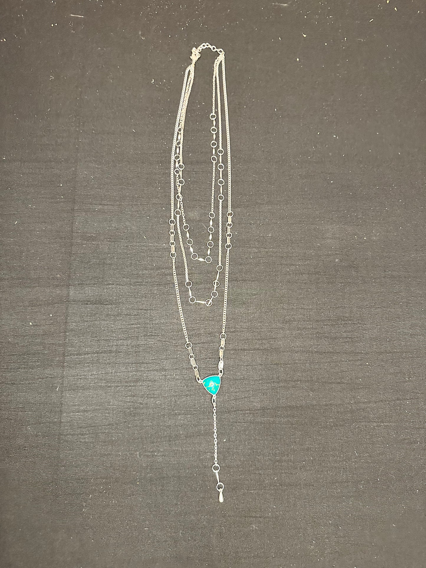 3 layered silver necklace with a turquoise stone
