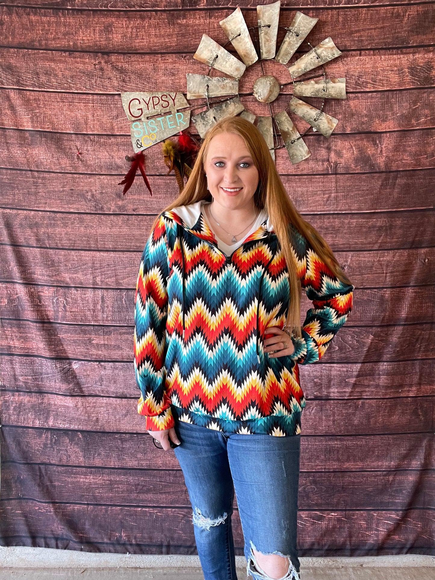 Model wearing bright Aztec print quarter zip hoodie in size large