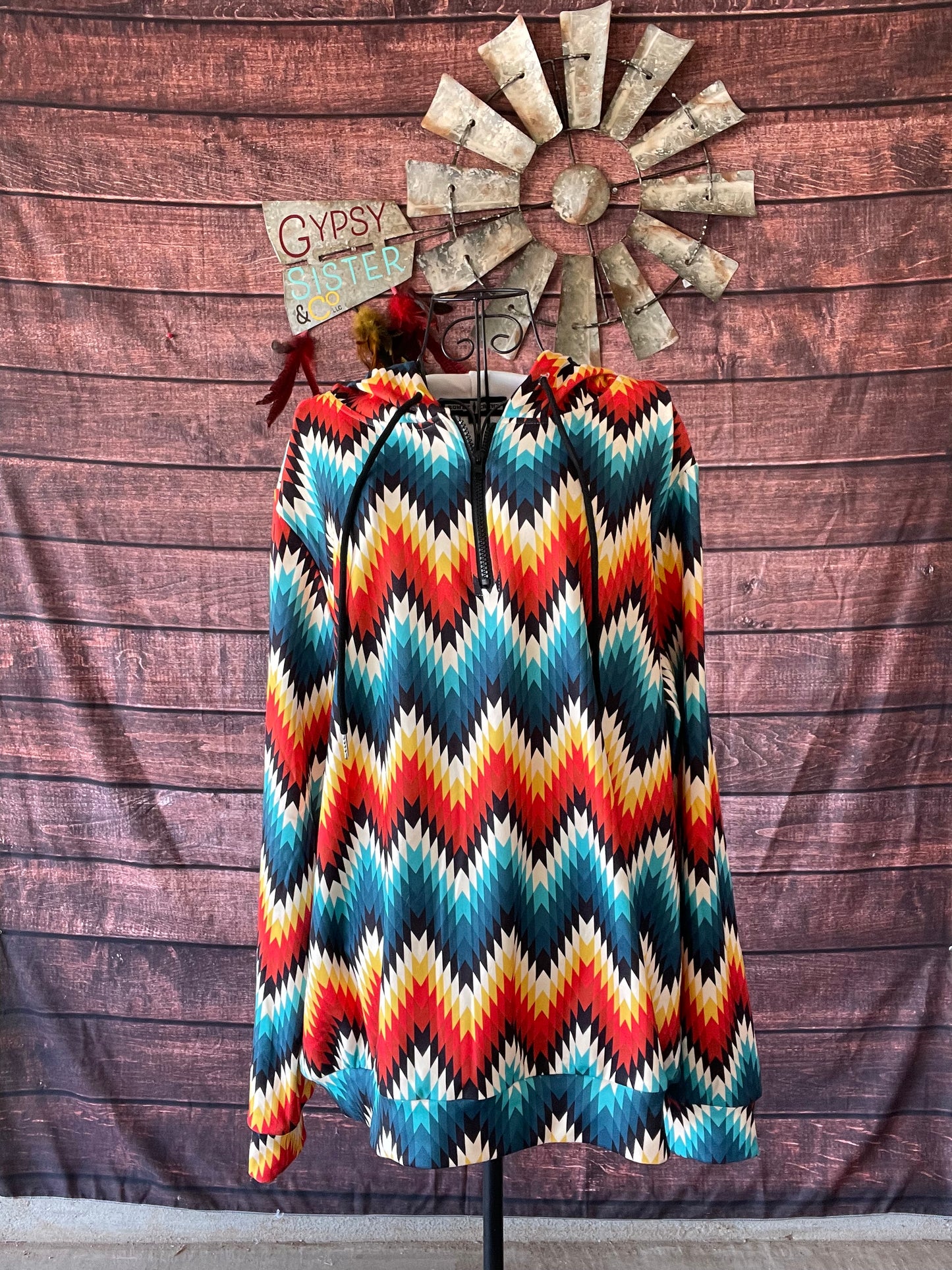 Quarter zip hoodie in bright aztec print on a mannequin