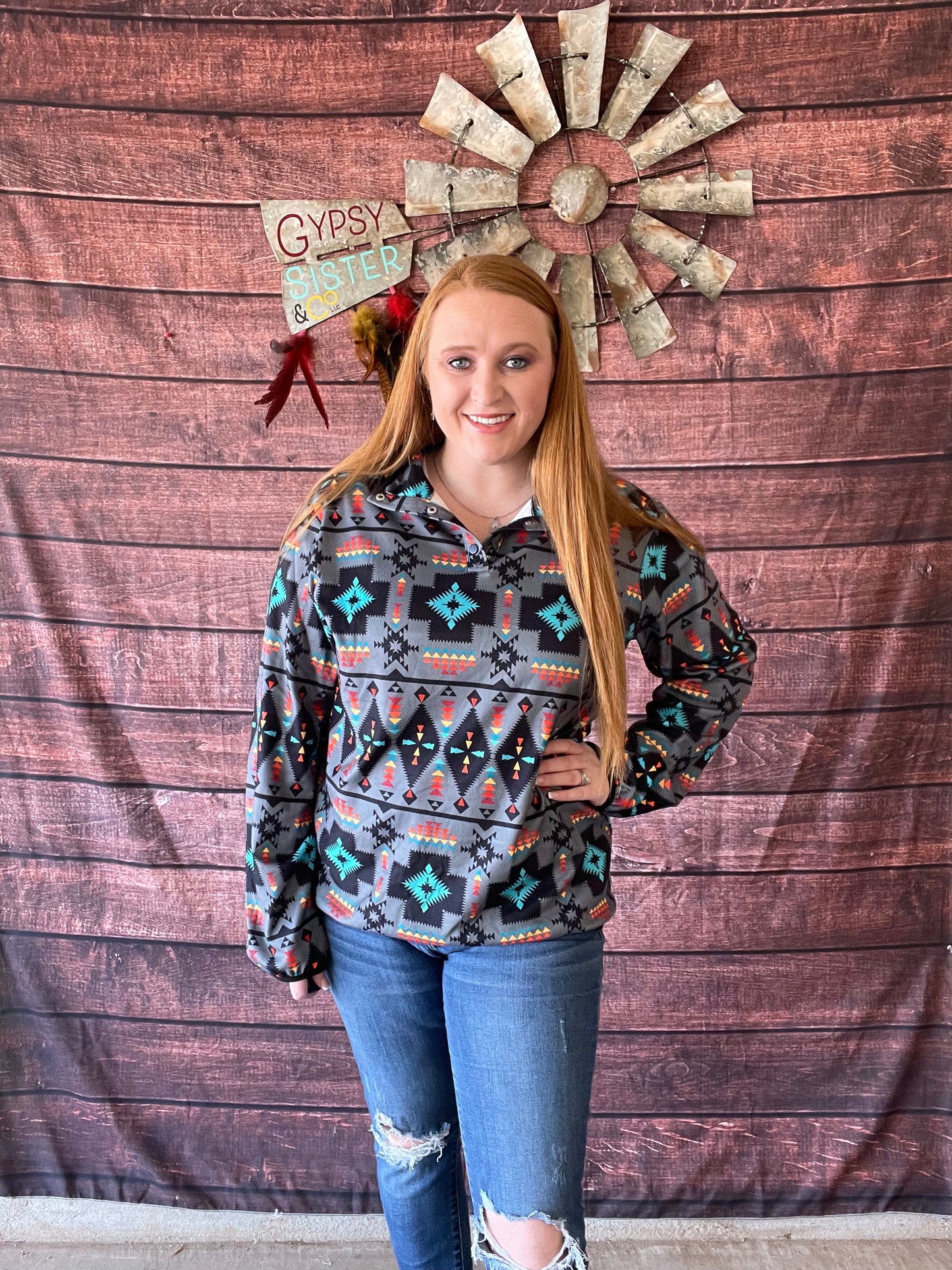 Model wearing Aztec print light grey quarter button pullover in size large