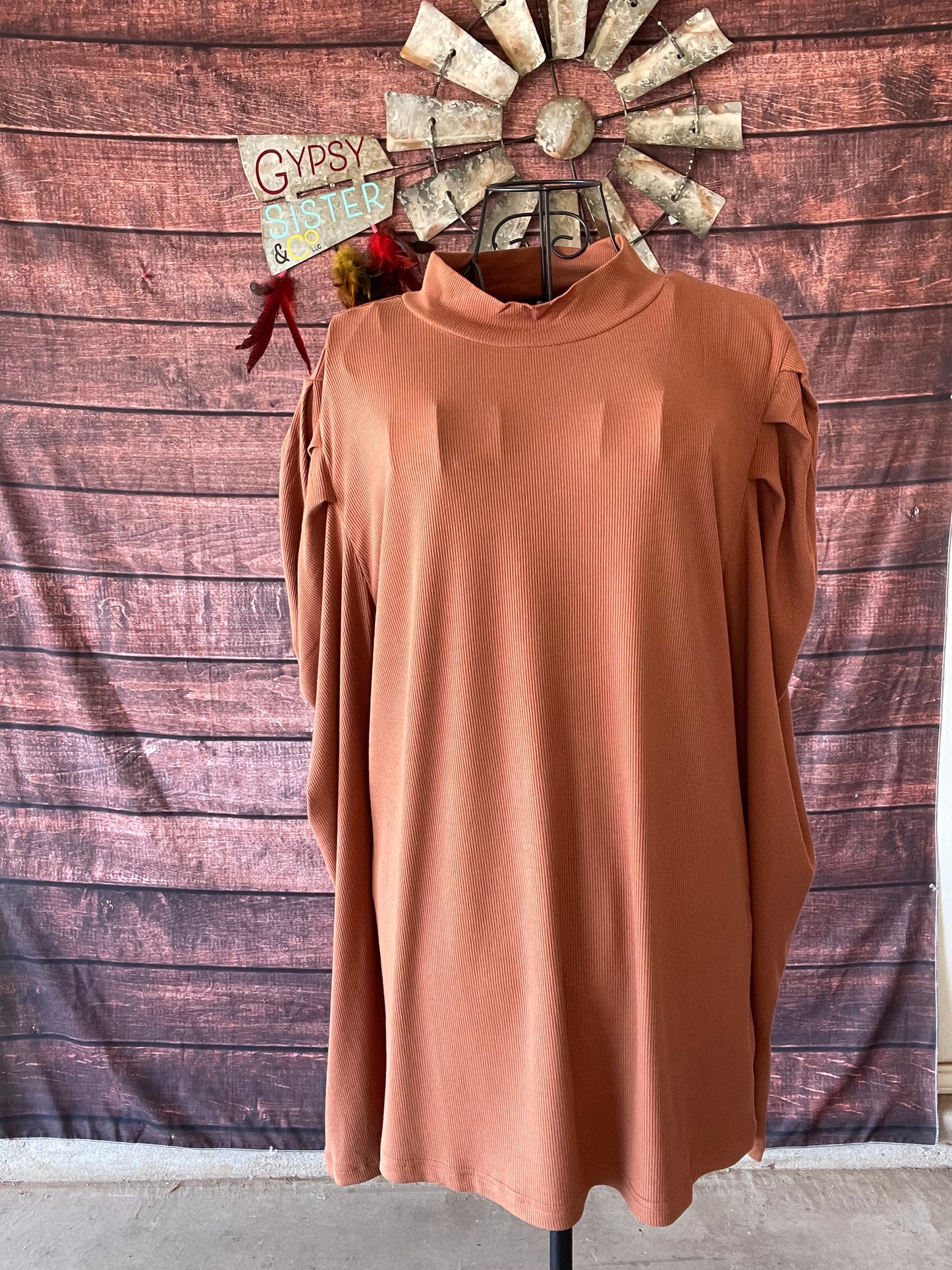 Brown top with mock neck and puffy sleeves on a mannequin