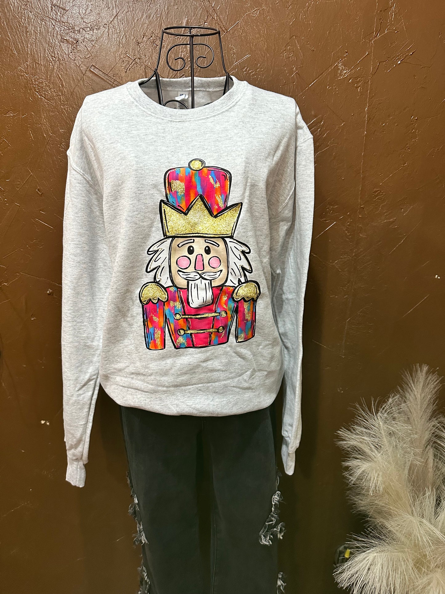 light grey sweatshirt with sassy and colorful nutcracker on a mannequin