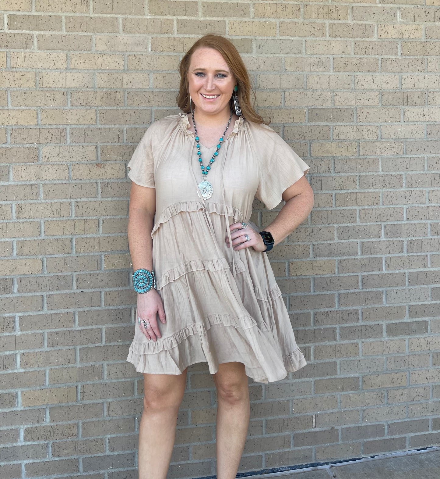 Model wearing ruffle tiered khaki dress