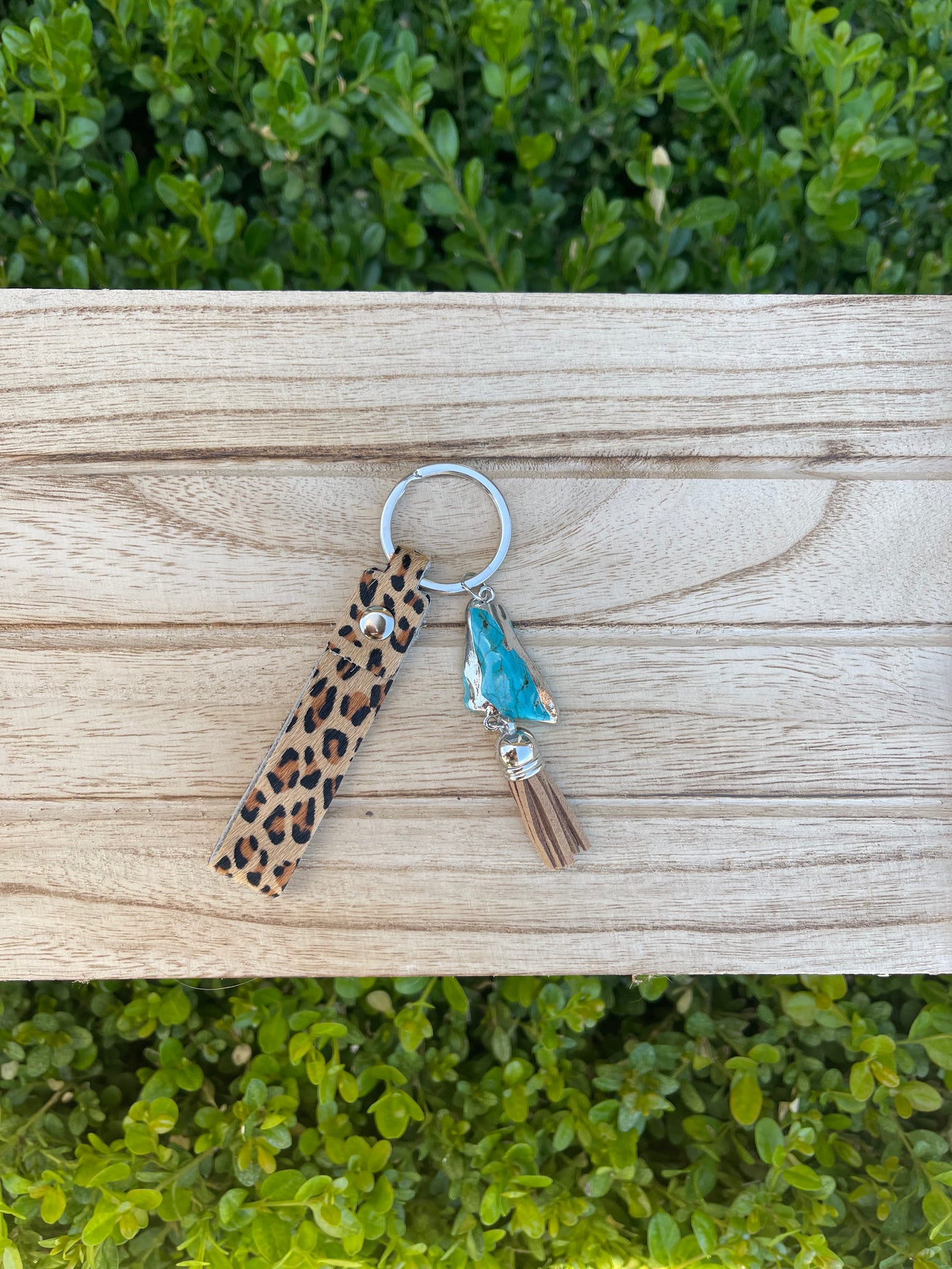 key chain with brown and black cheetah print loop, turquoise stone, and light brown tassel