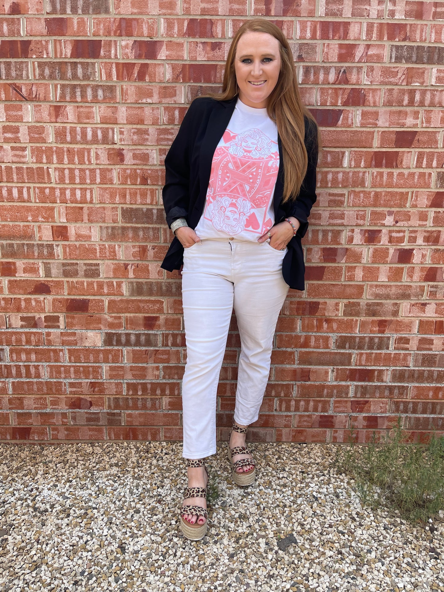 Model wearing Queen of Hearts shirt with white capri pants, black blazer and Cheetah print platform sandals