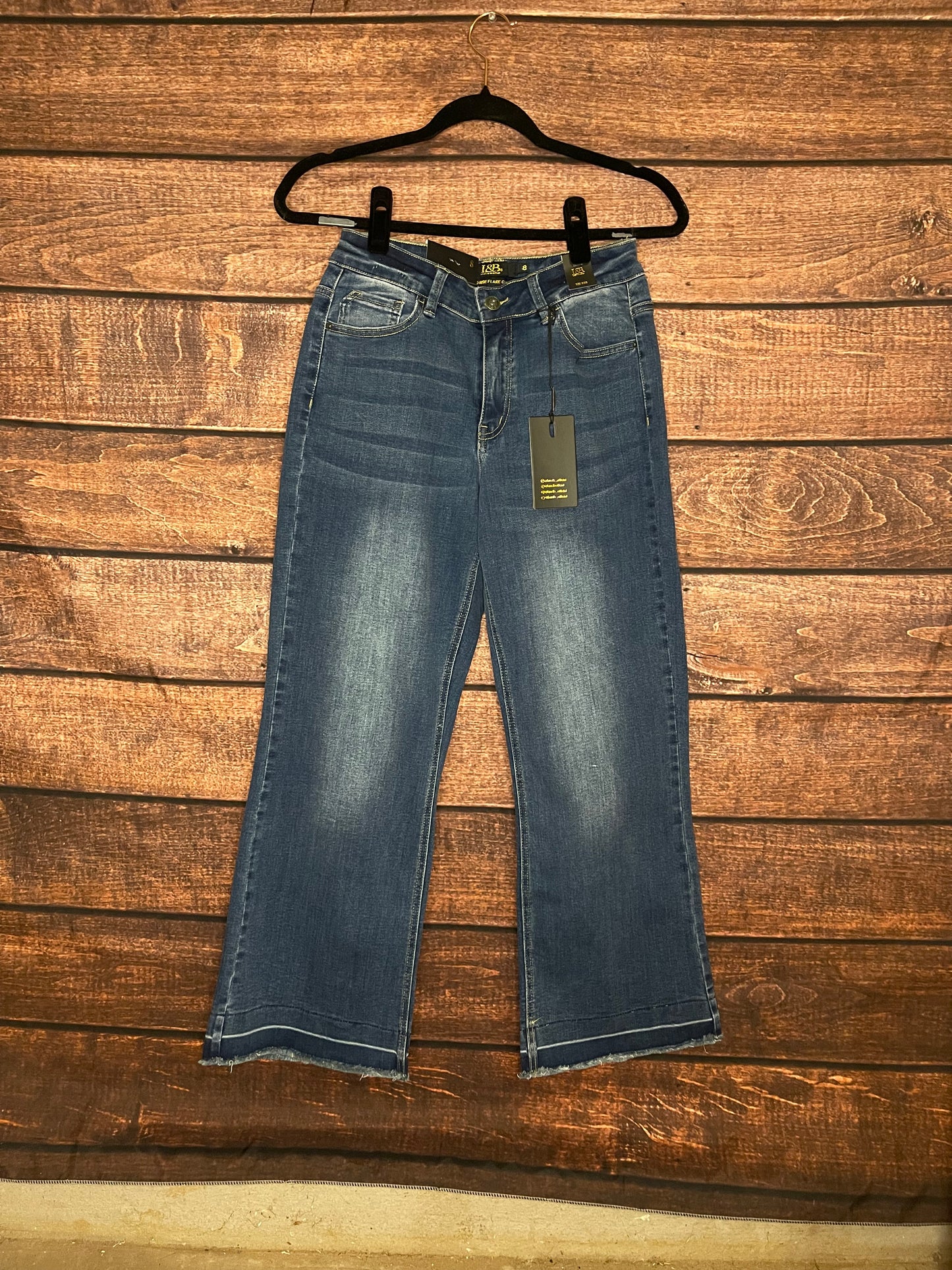 Front of mid-high rise, dark wash, wide leg denim capri pants
