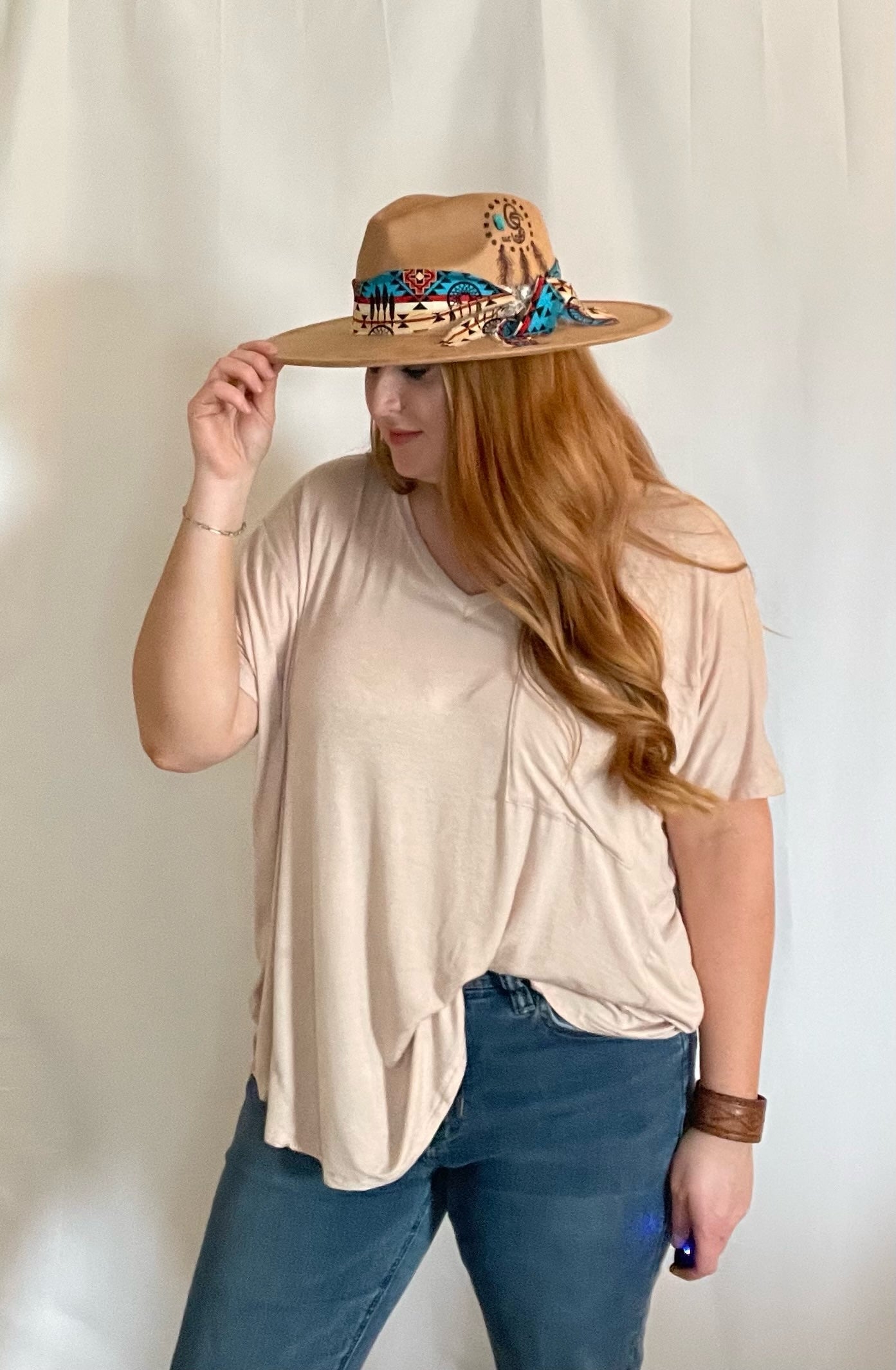 Model wearing Taupe oversized pocket t-shirt with a front/side tuck