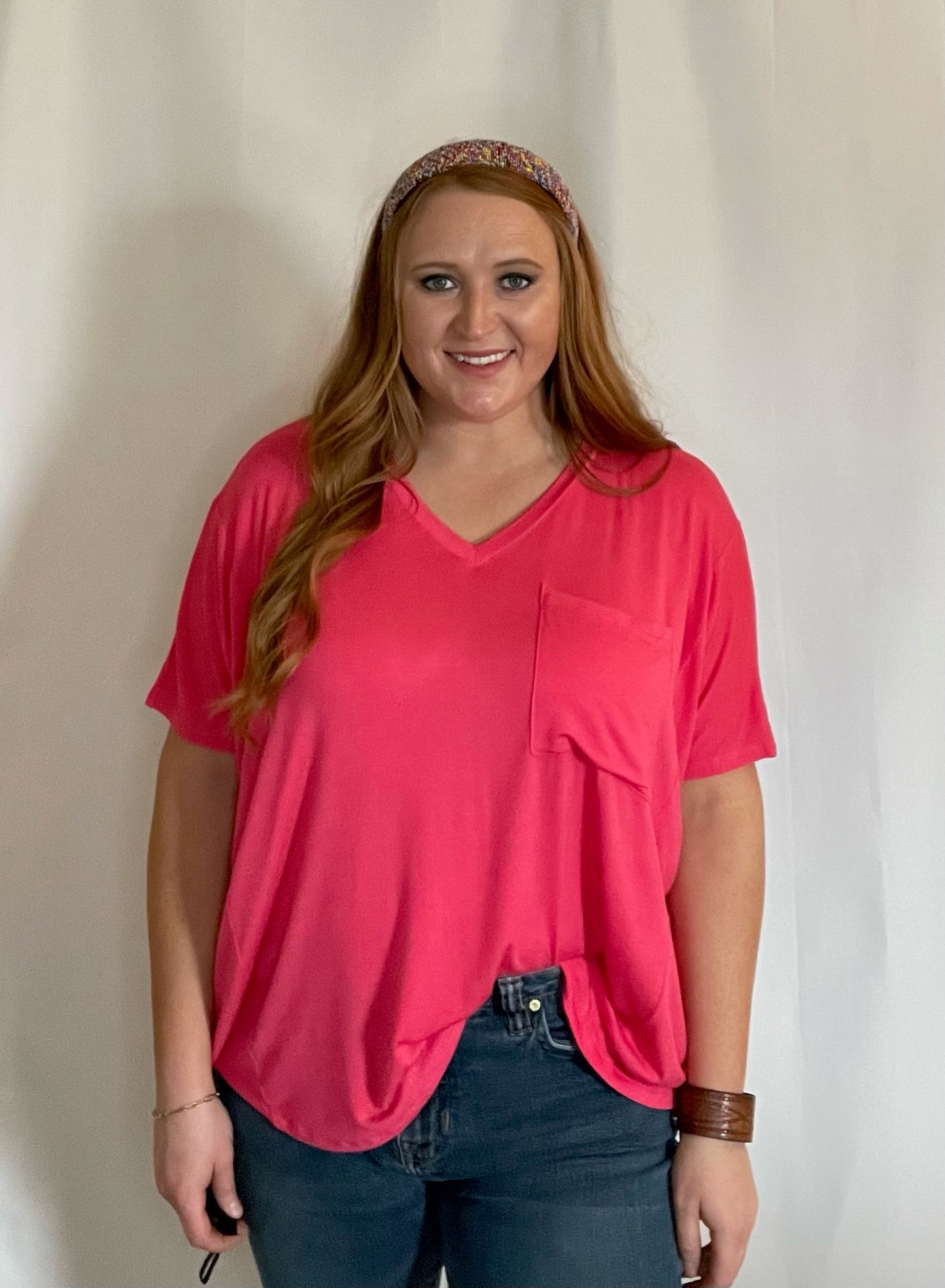 Model wearing Coral oversized pocket t-shirt with a front/side tuck