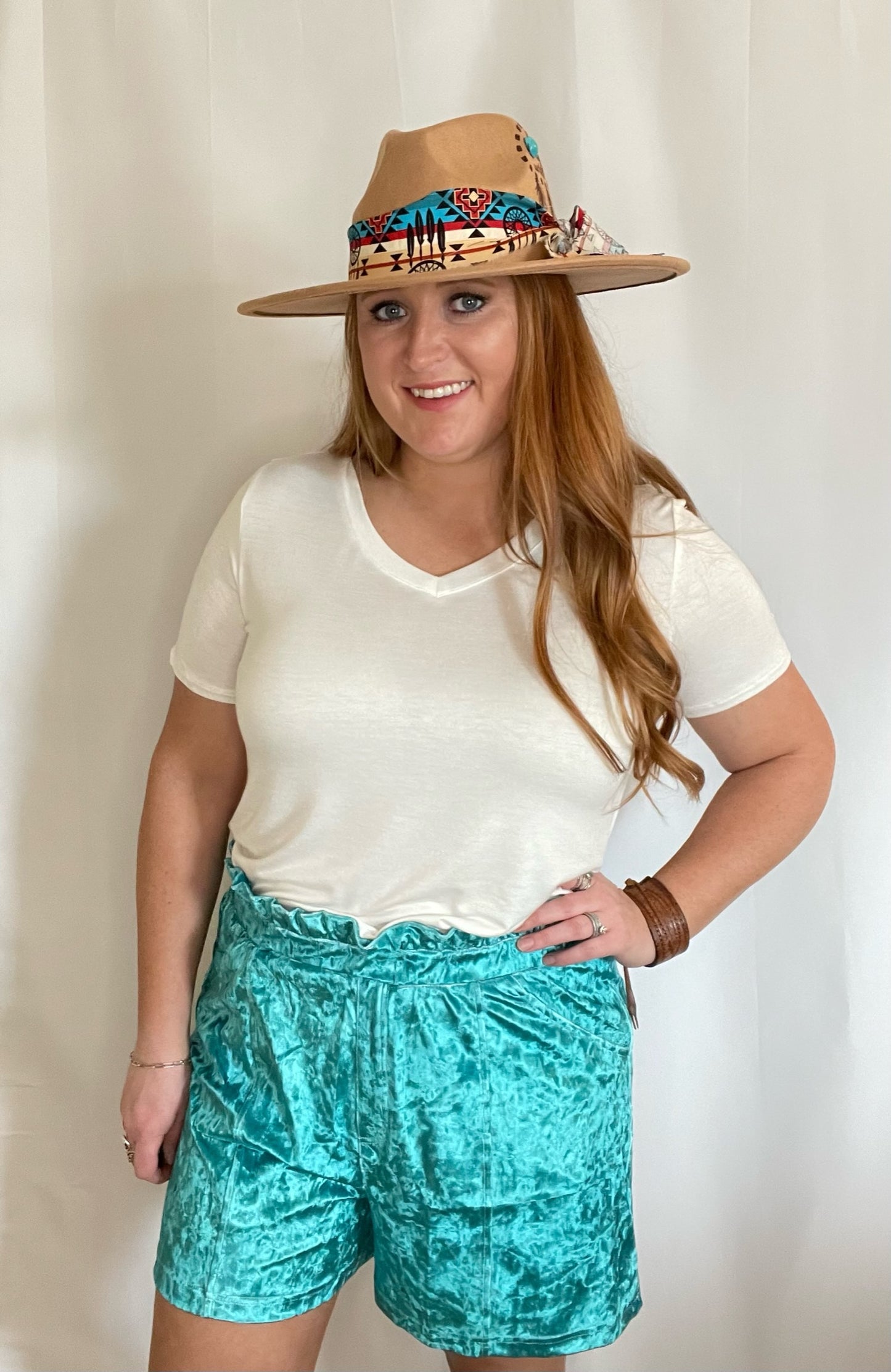 Model wearing velvet Turquoise shorts and white t-shirt