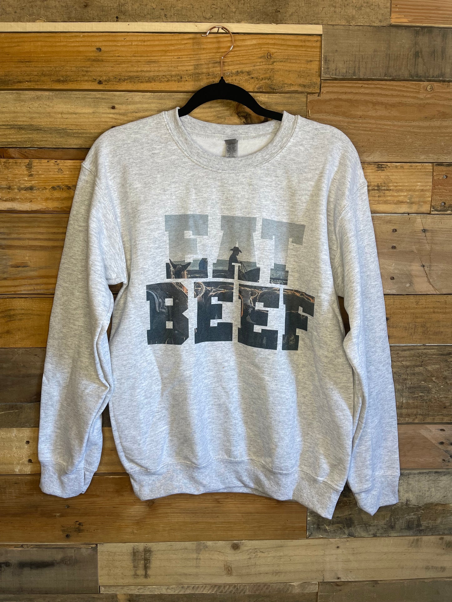 Light grey sweat shirt that says Eat Beef with a cowboy and cow in the letters