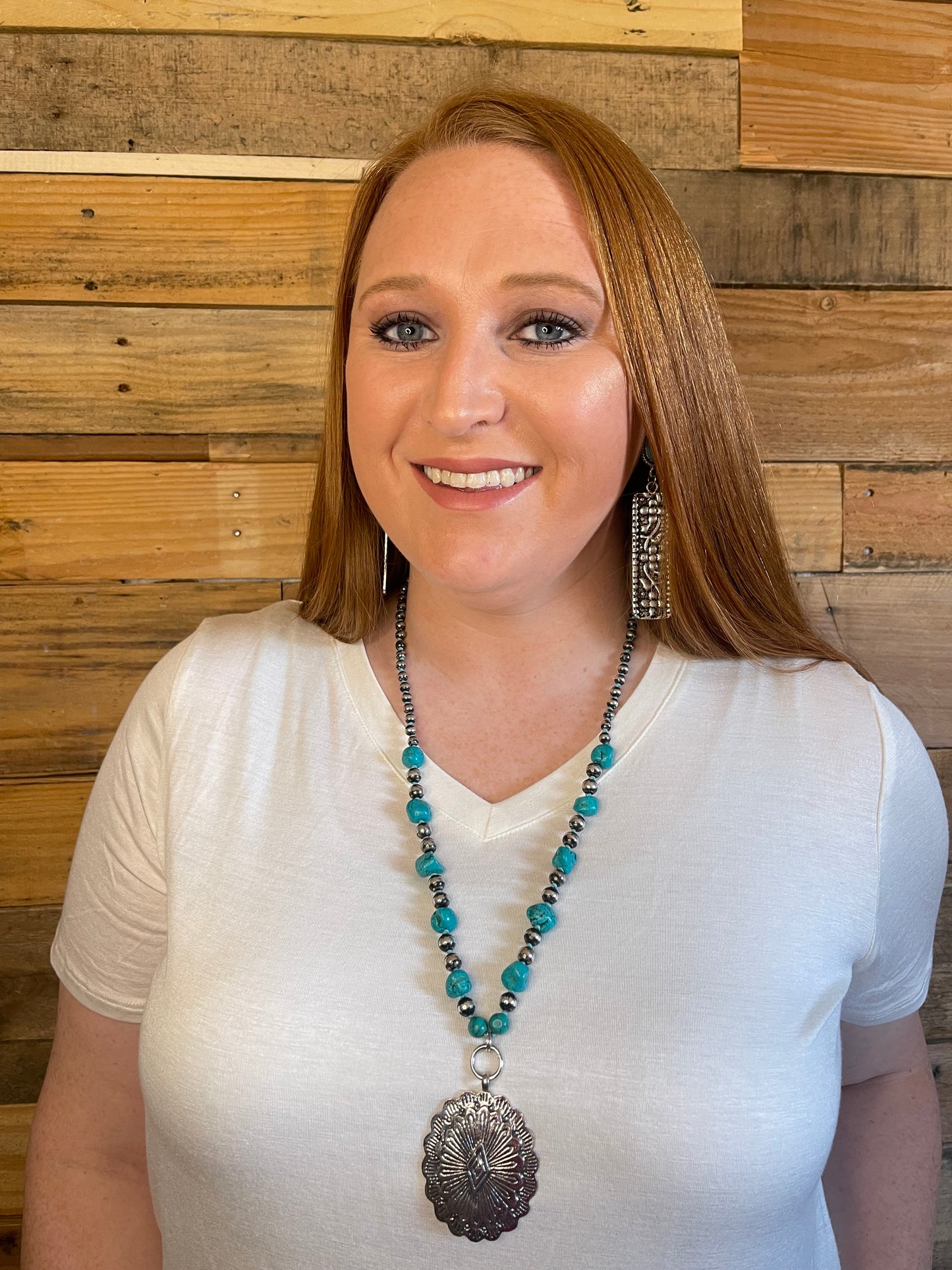 Woman wearing Navajo Pearl and turquoise stone necklace with silver concho