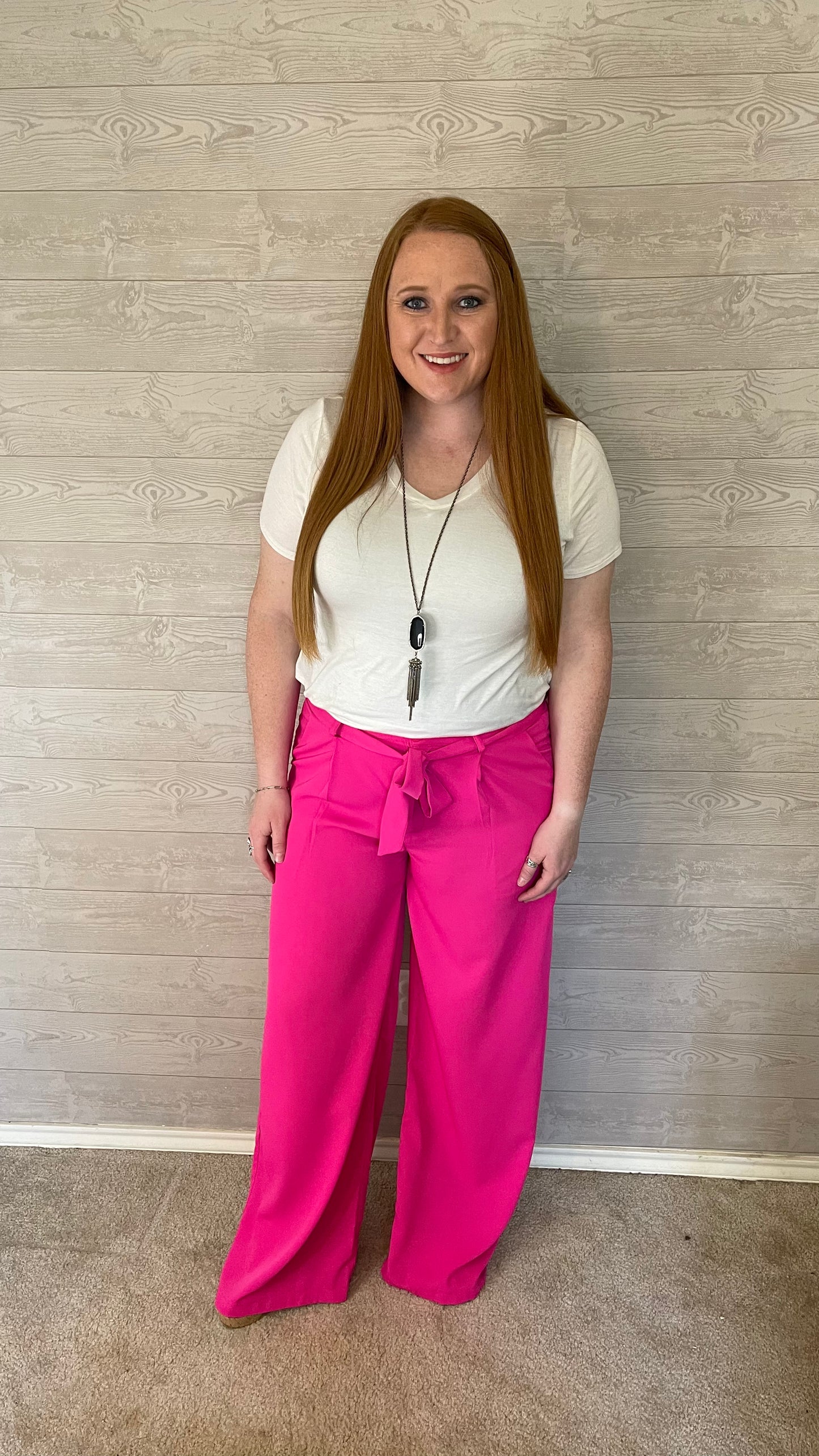 Model wearing pink wide leg pants with a white shirt