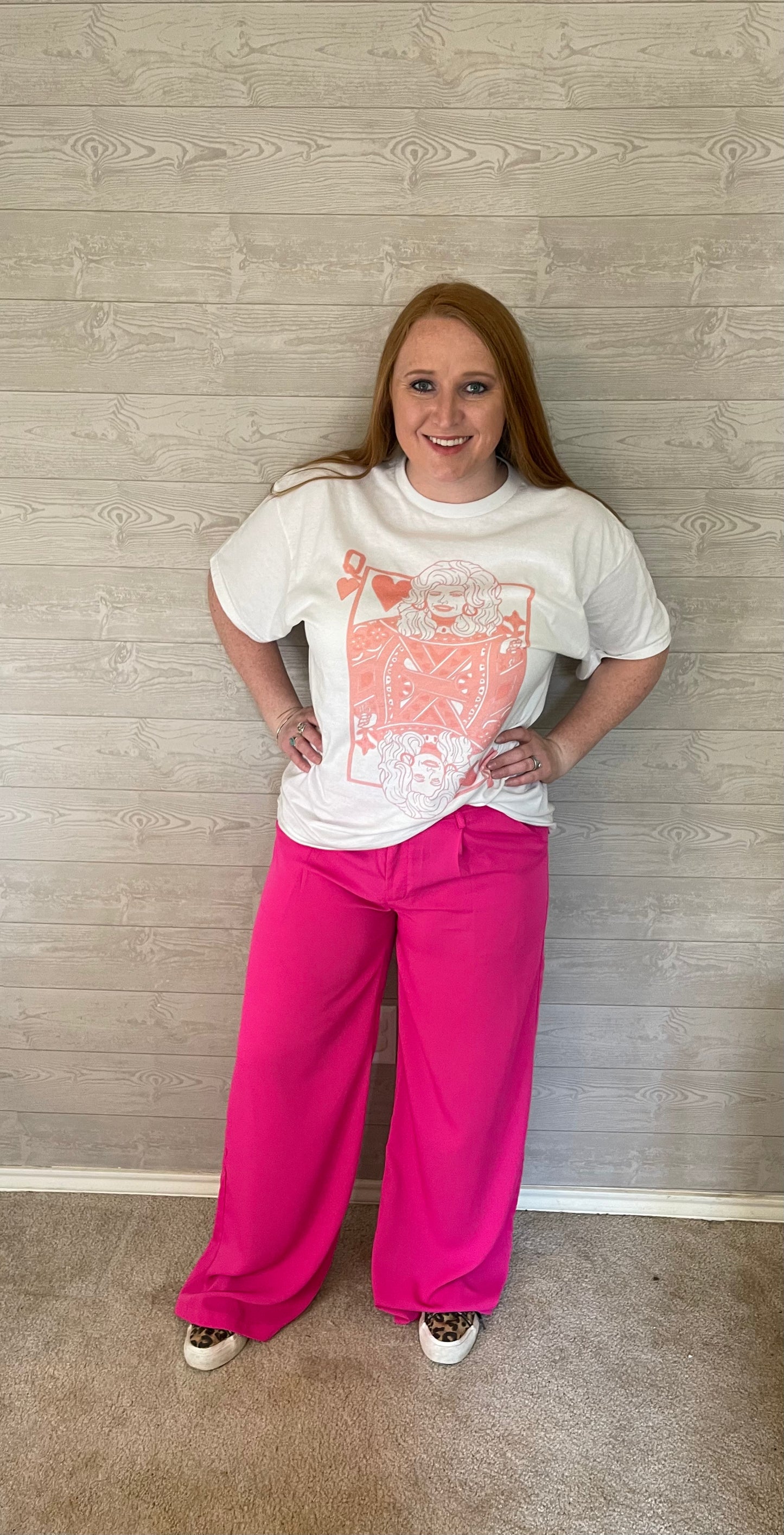 Model wearing Dolly Parton shirt with pink wide leg pants and cheetah print shoes