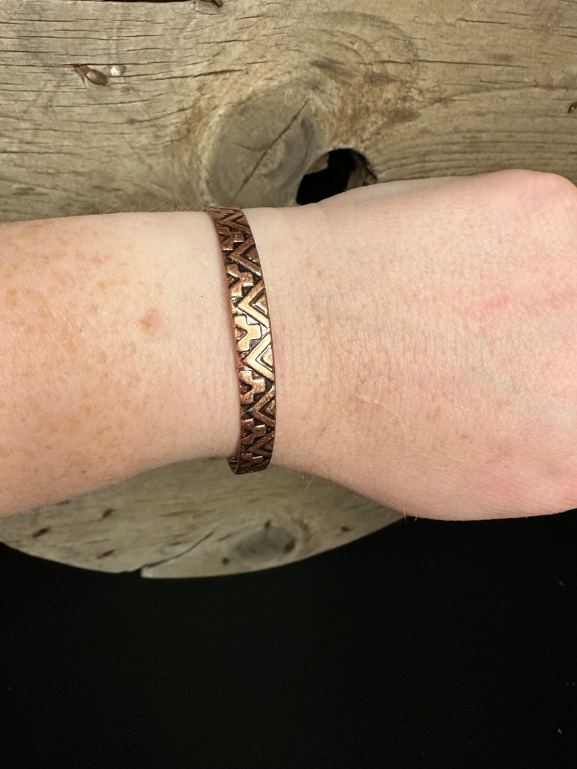 Copper Aztec stamped cuff on wrist 