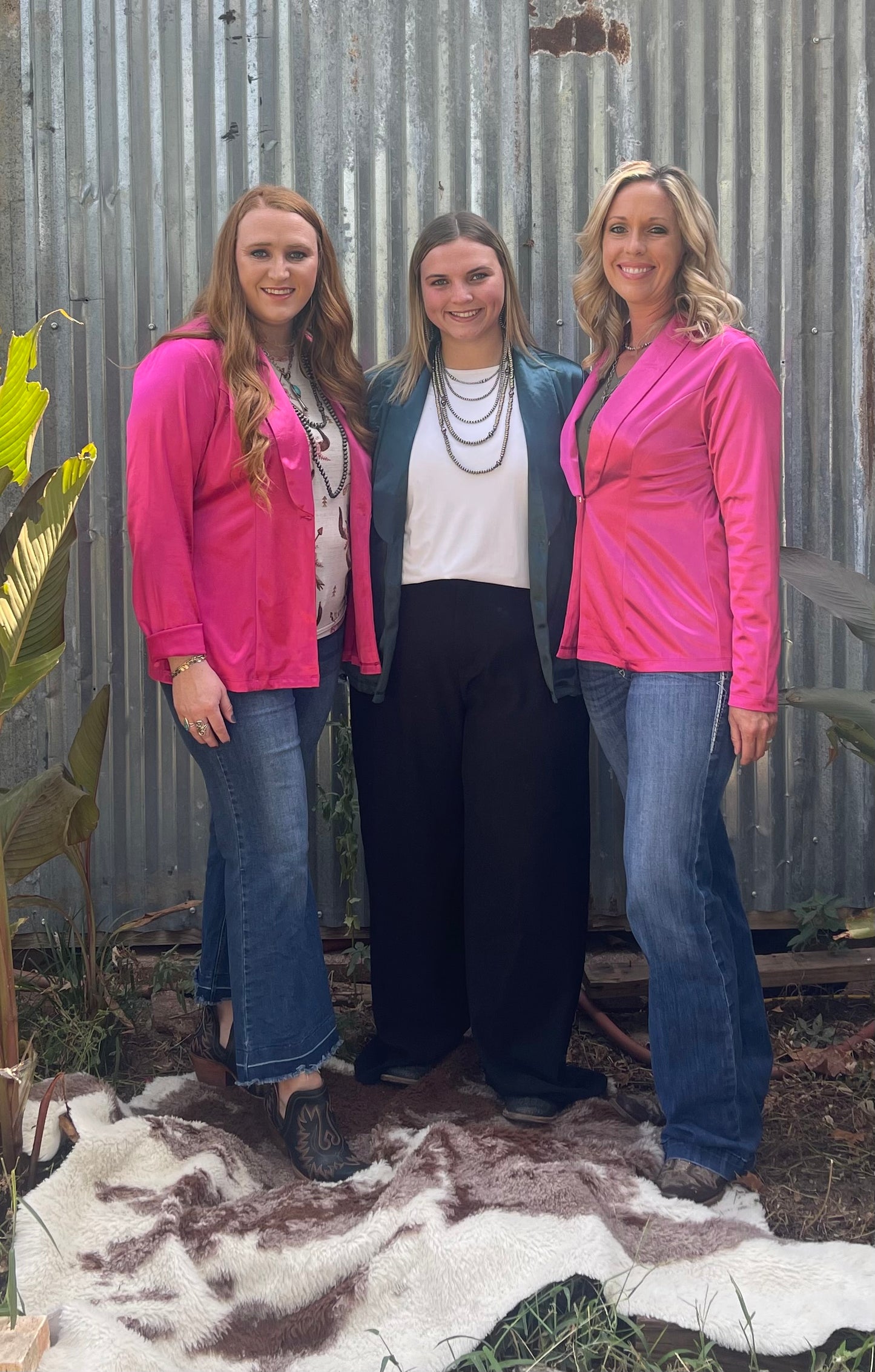 three women wearing silky blazers in different sizes 