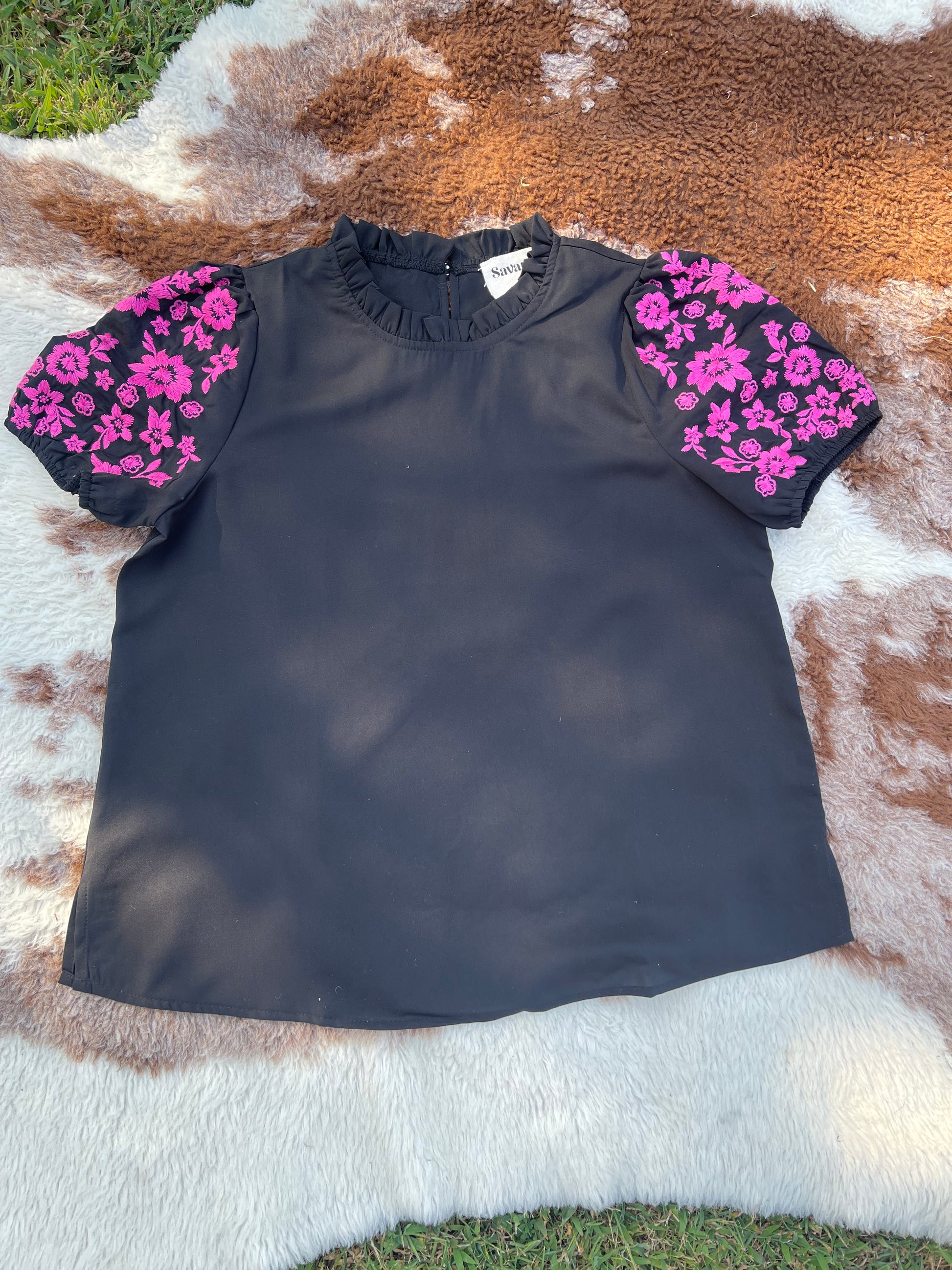 Black short puff sleeve shirt with pink embroidered flowers on the sleeves 