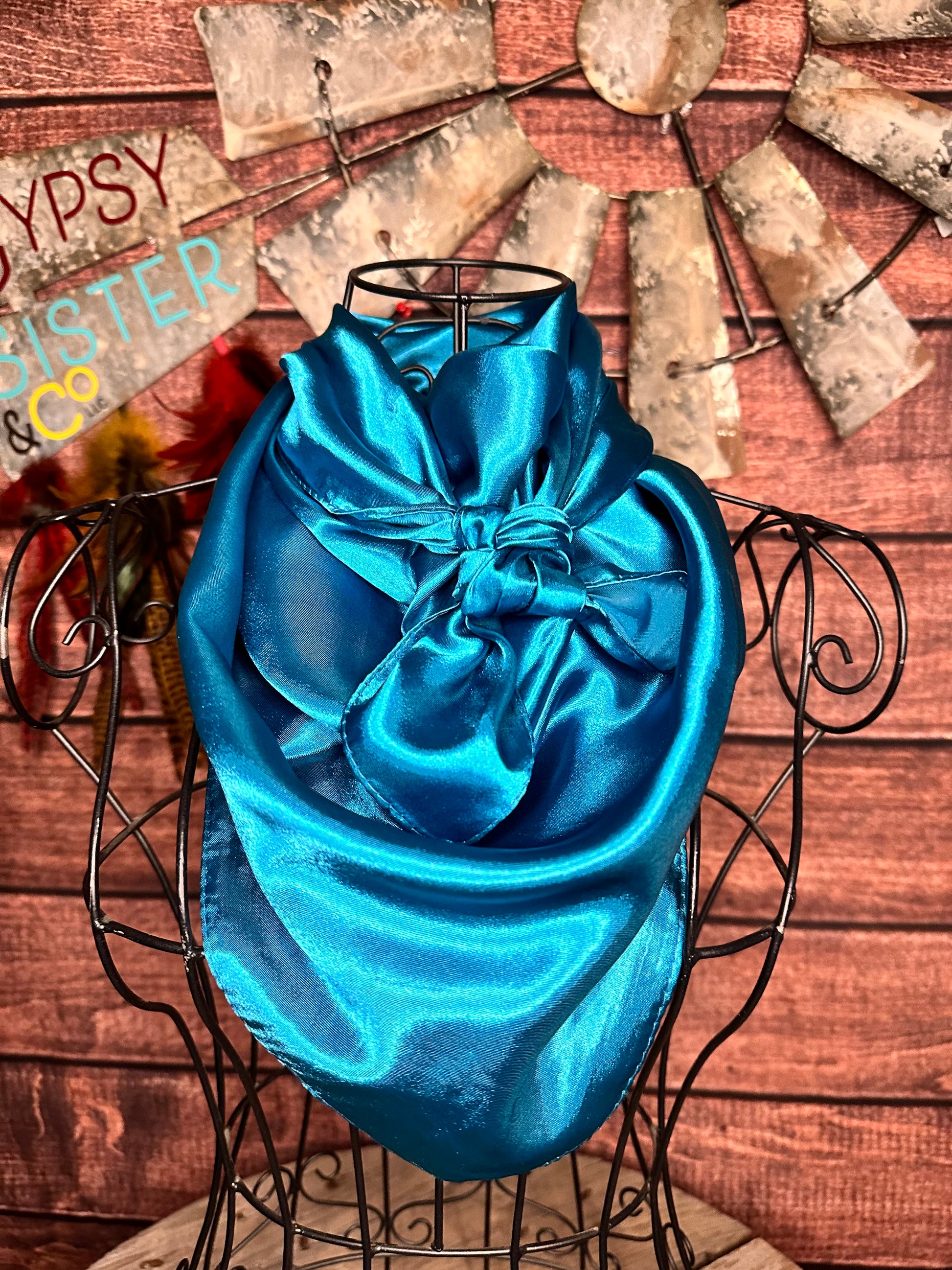 Turquoise silky wild rag tied on a mannequin 