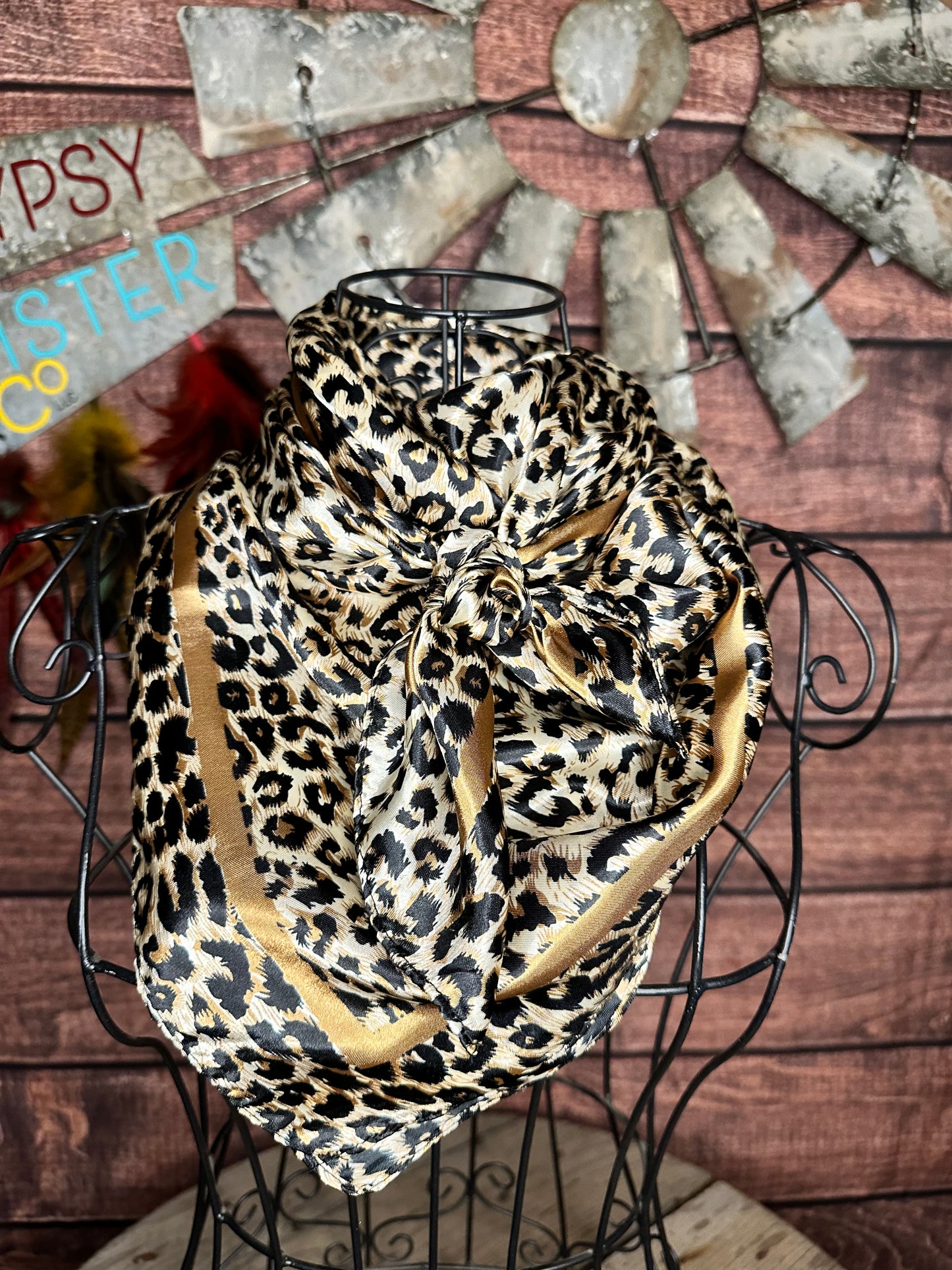 Liberty Leopard Wild Rag: leopard print silk wild rag with gold border tied on a mannequin 