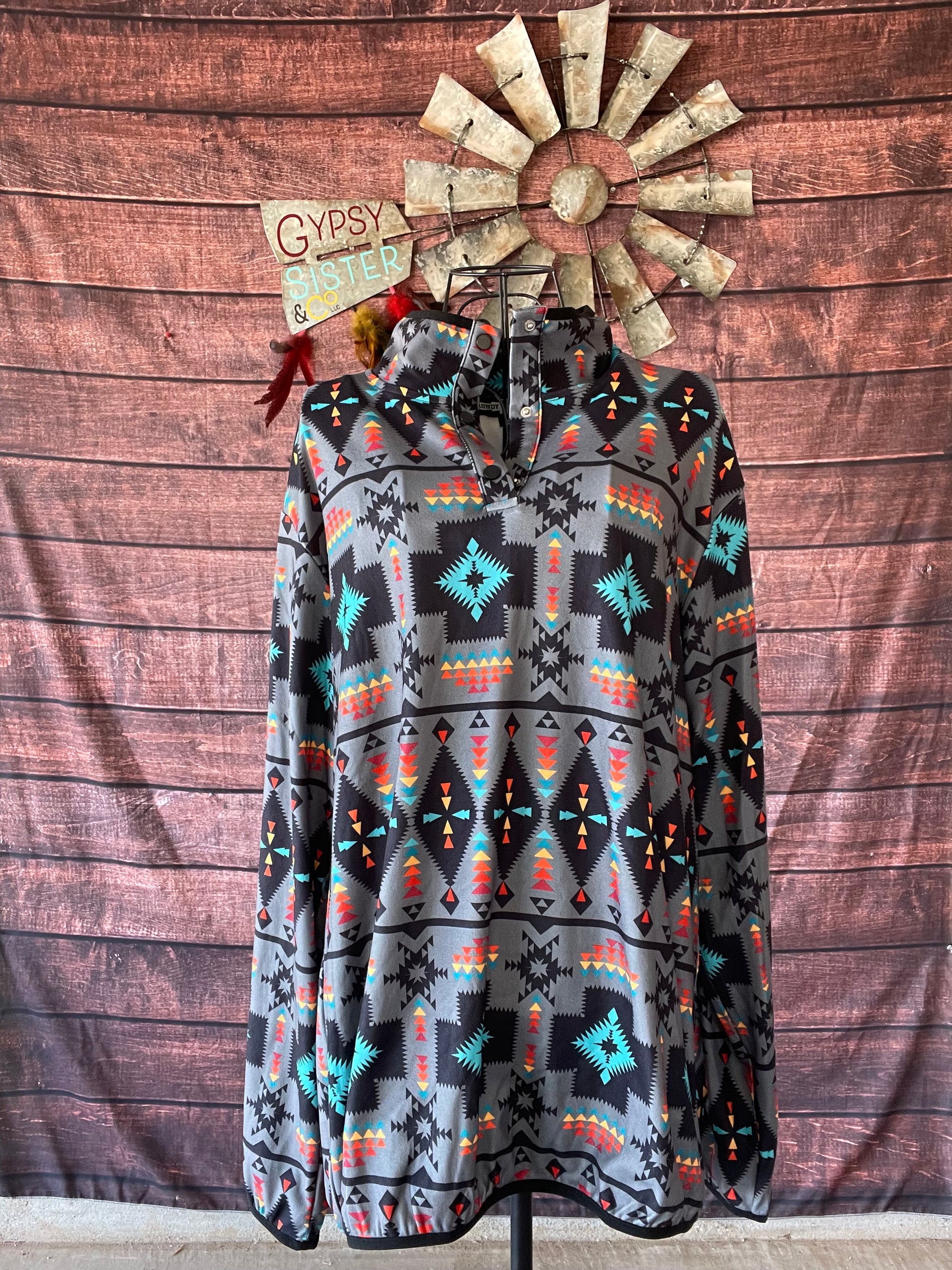 Aztec printed light gray pullover with quarter button neck on a mannequin