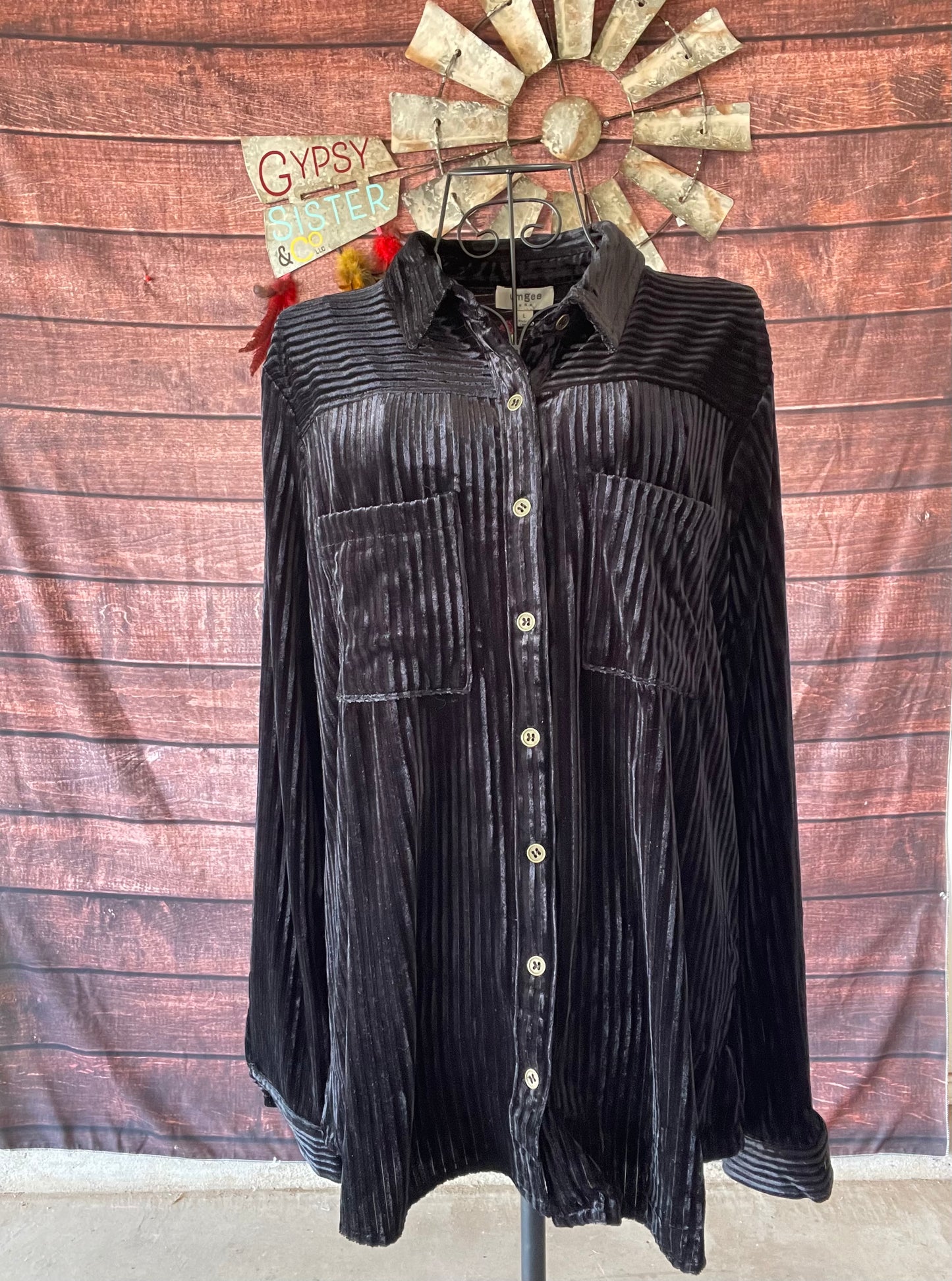 Black velvet button down shirt on mannequin 