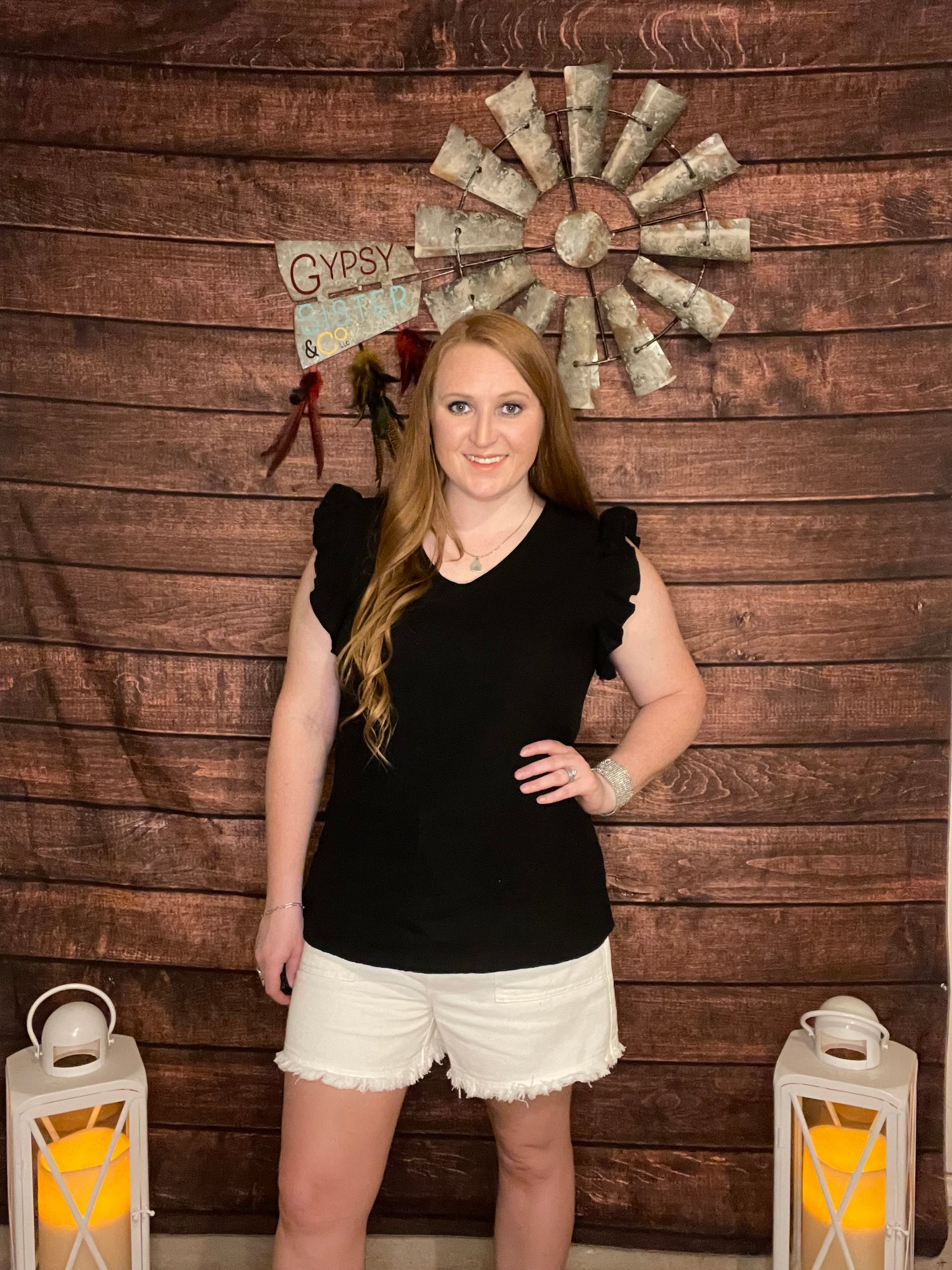 Model wearing Black Ruffle Sleeve v-neck tank top