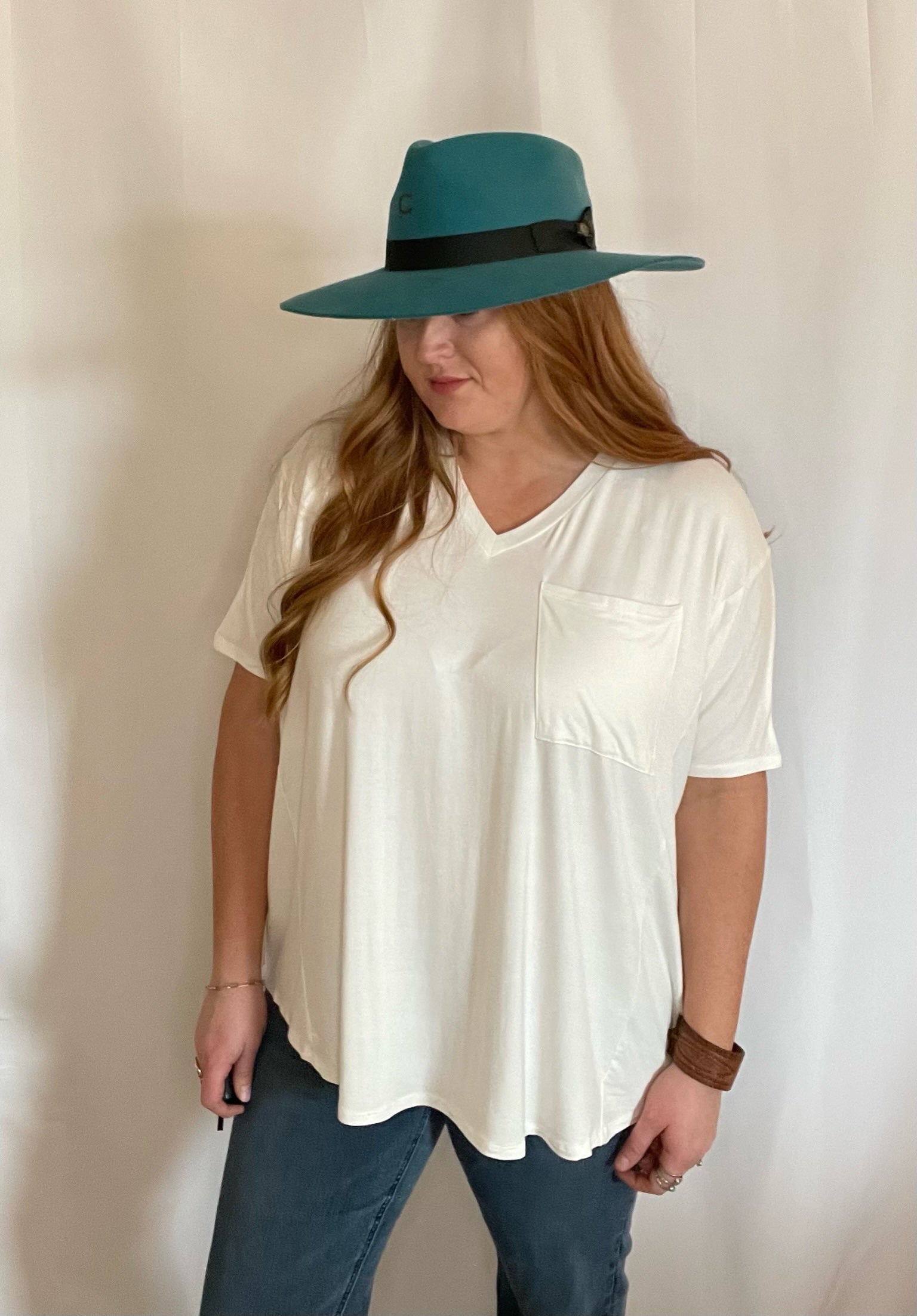 Model wearing oversized Off White pocket t-shirt untucked with a turquoise hat