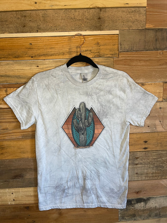 Grey tie-dyed shirt with a Cactus on a Turquoise stone and yellow and rust striped background 